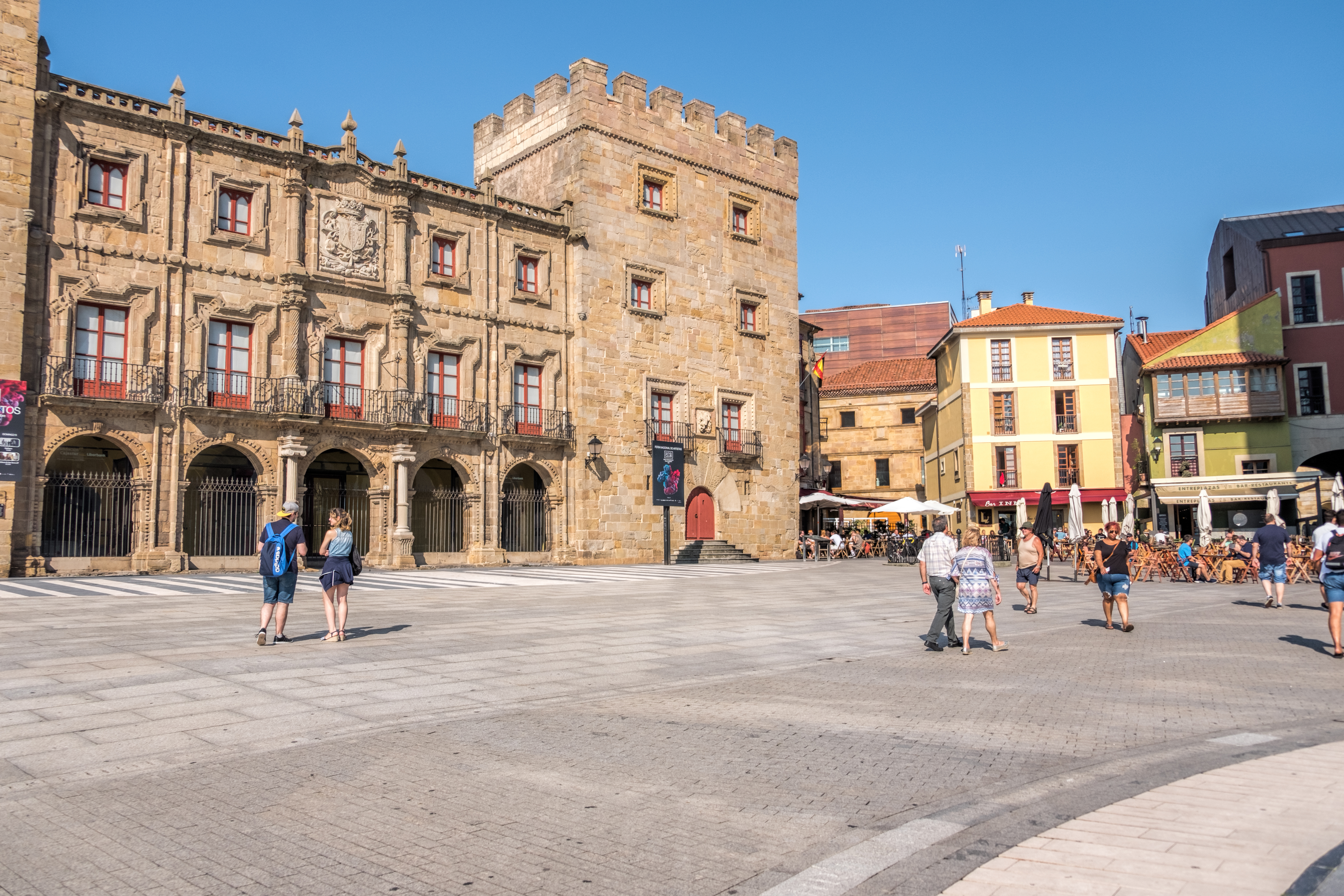 a group of people walking in a plaza