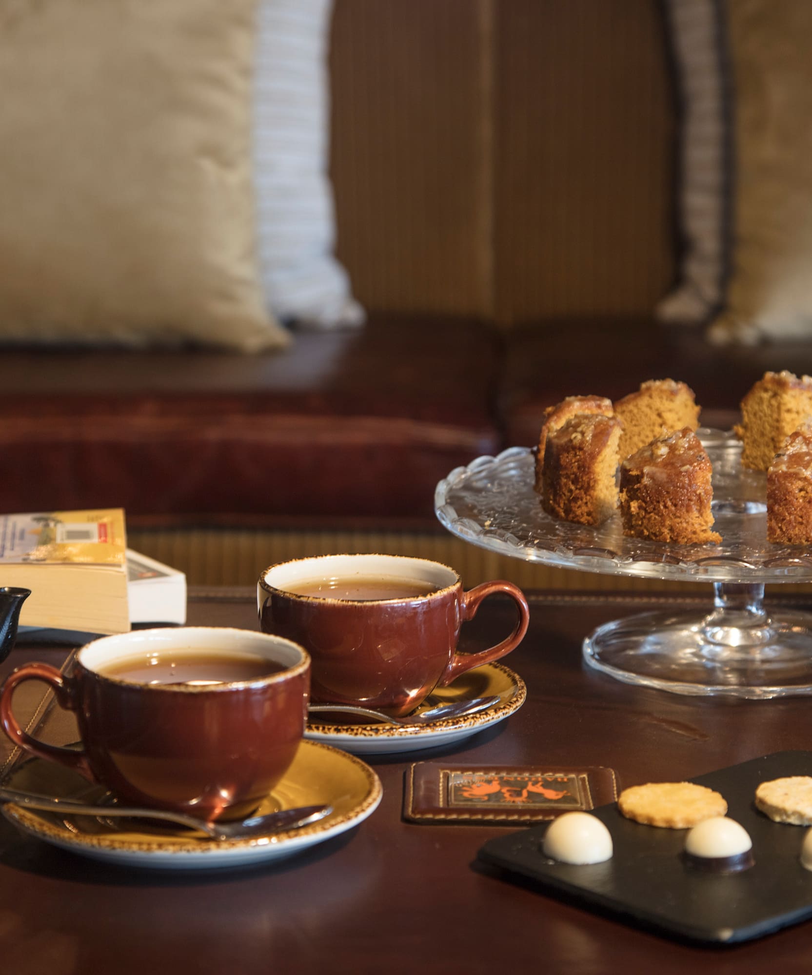 a table with tea cups and cookies