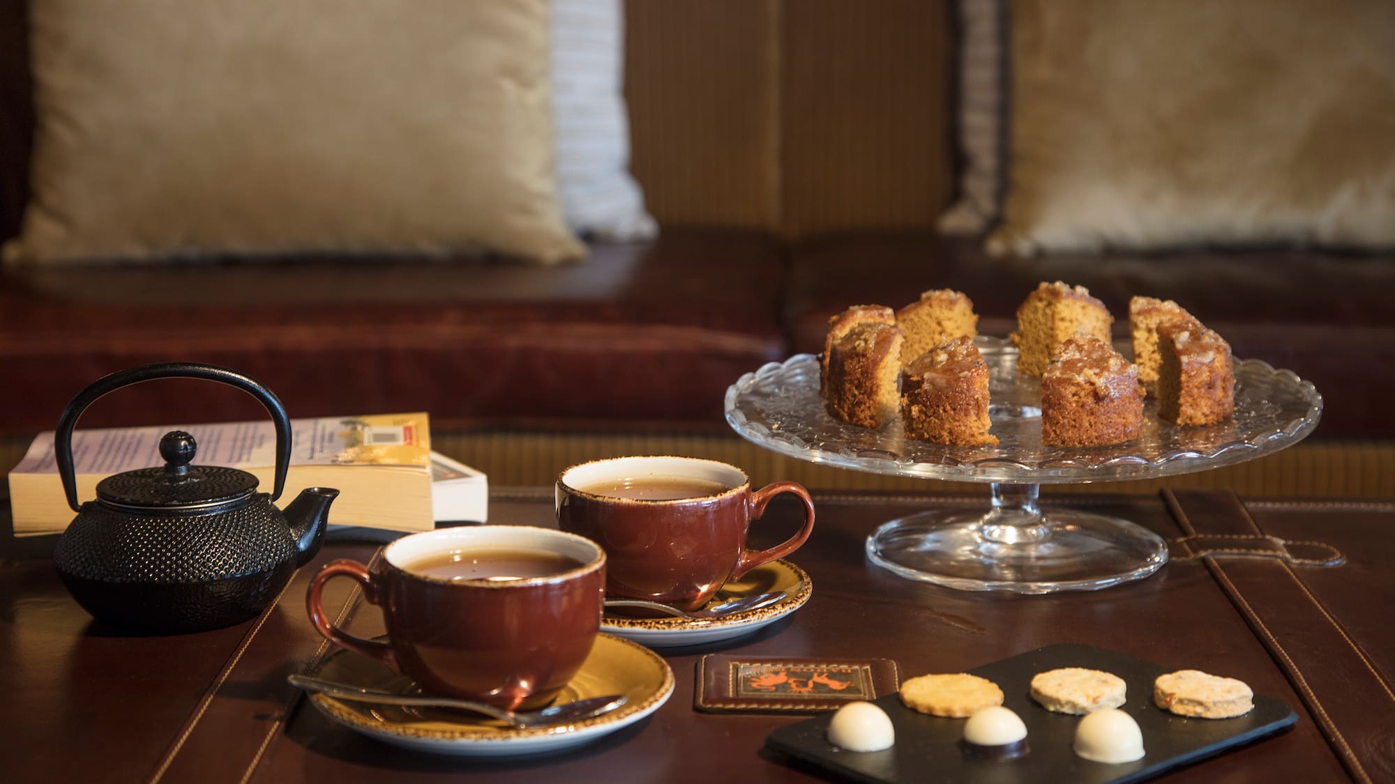 a table with tea cups and cookies
