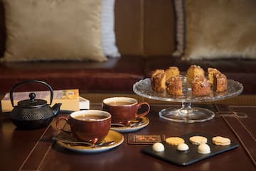a table with tea cups and cookies