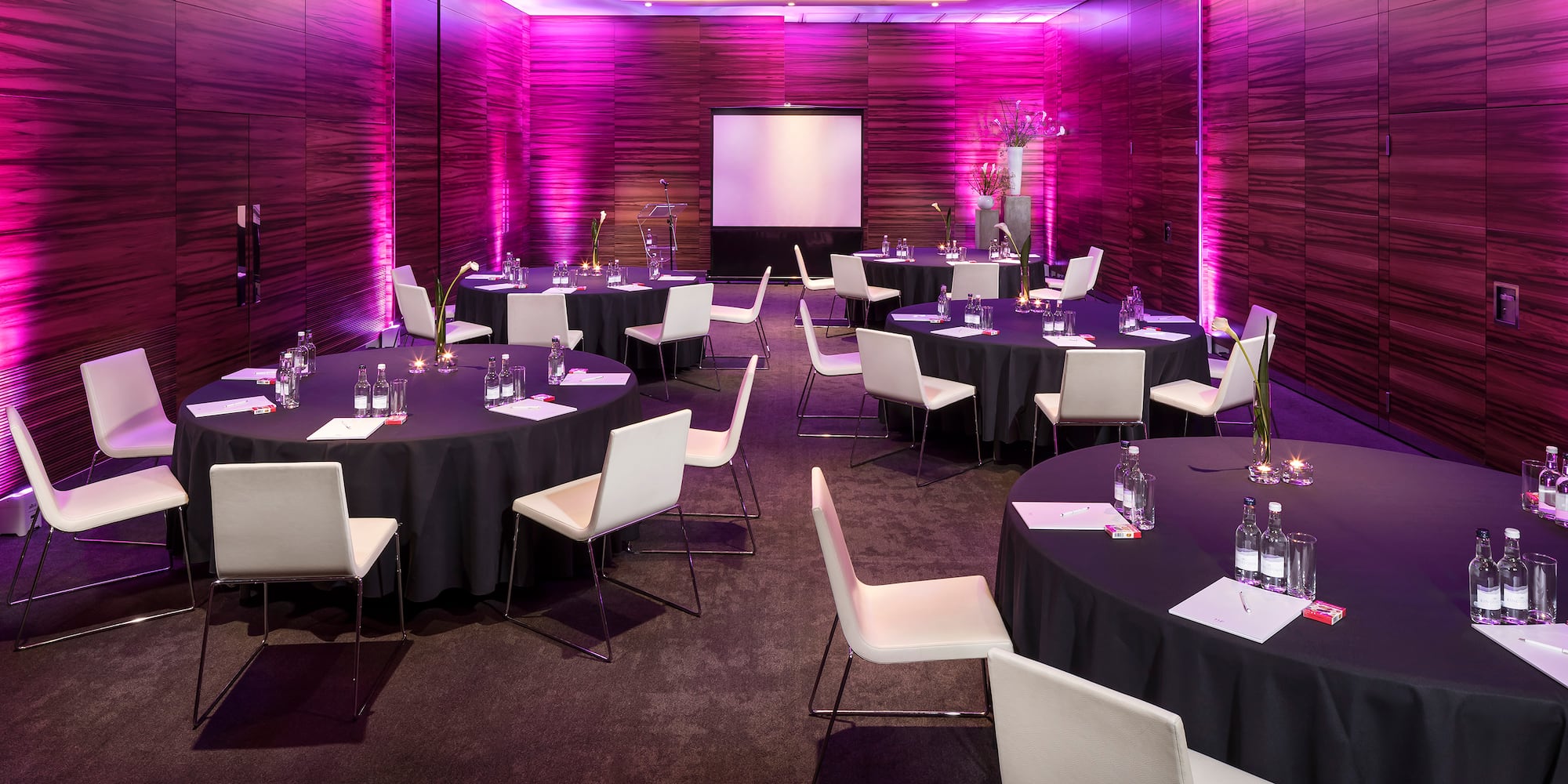 a room with round tables and chairs