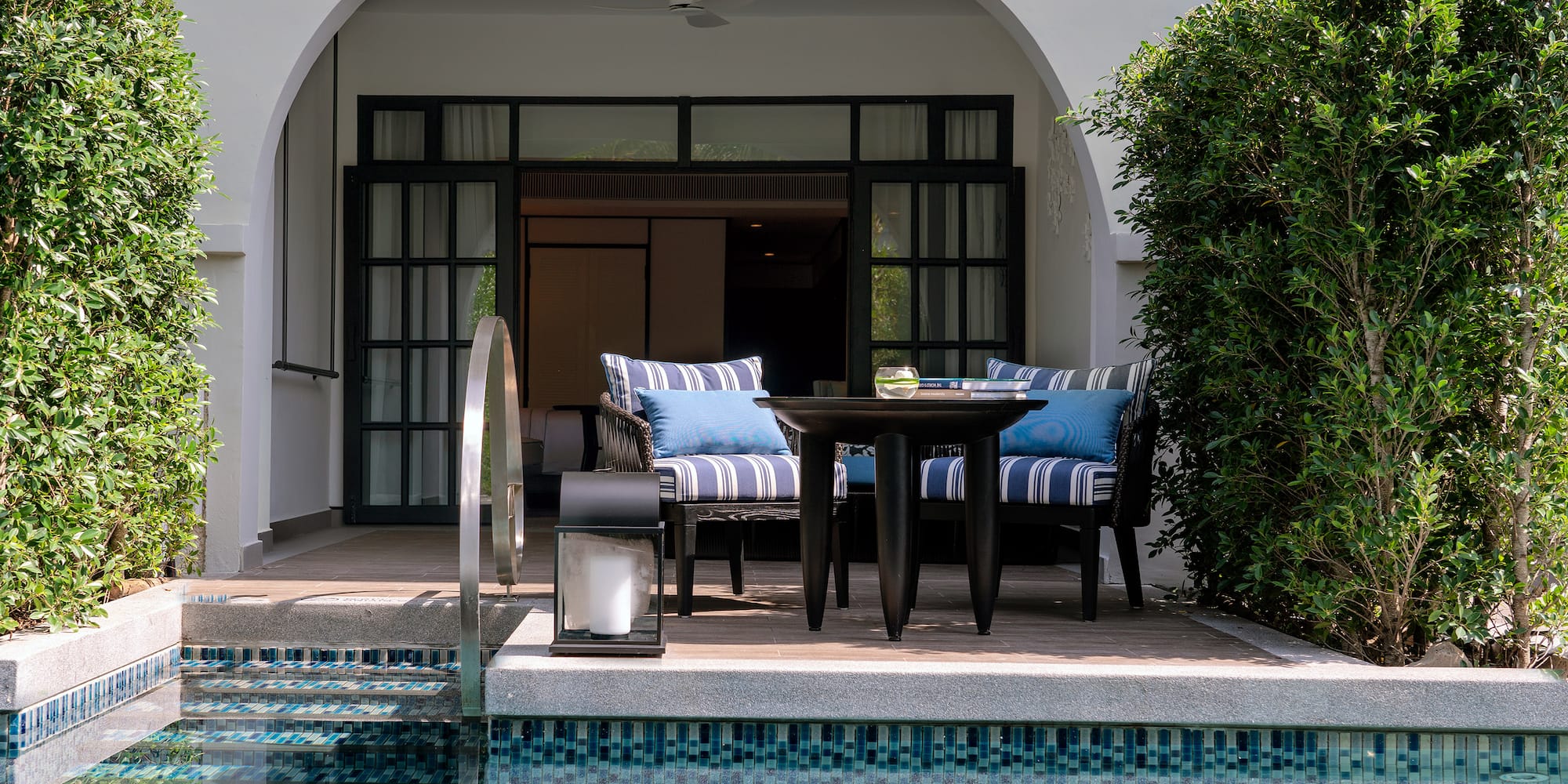 a pool with a table and chairs