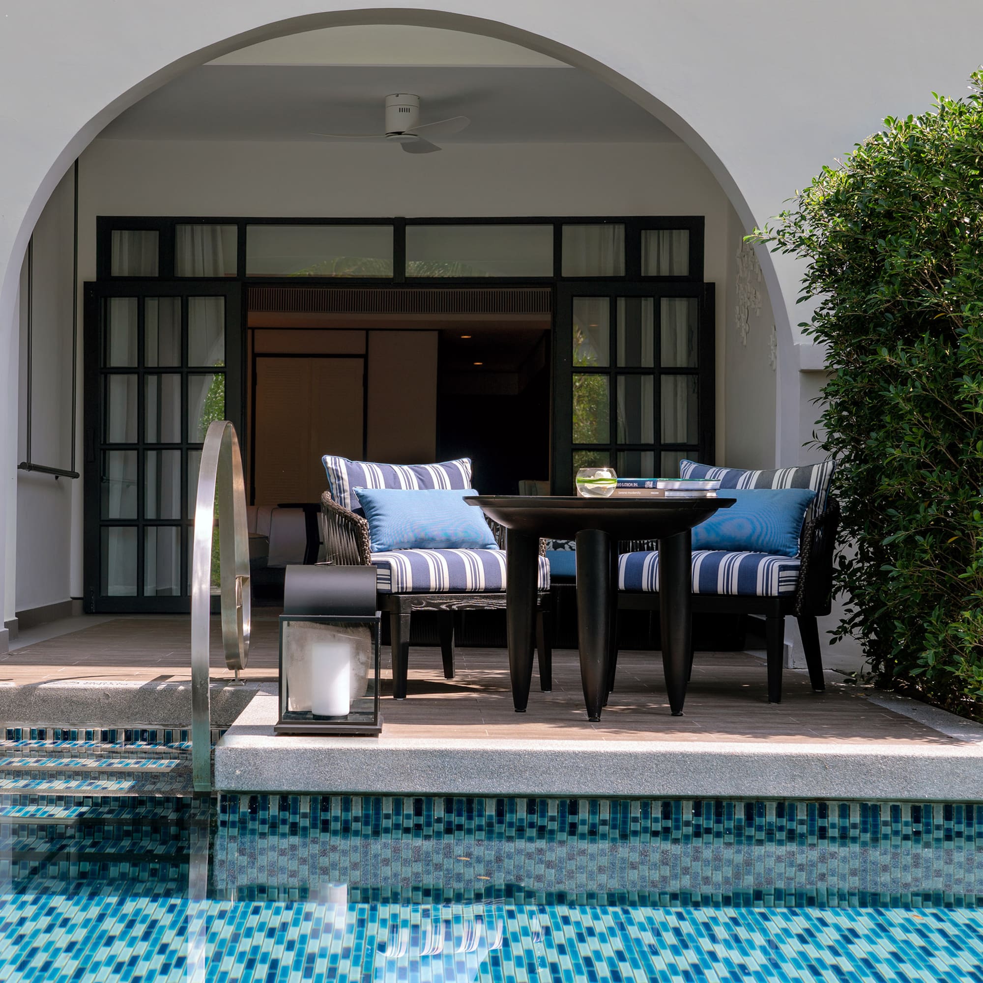 a pool with a table and chairs