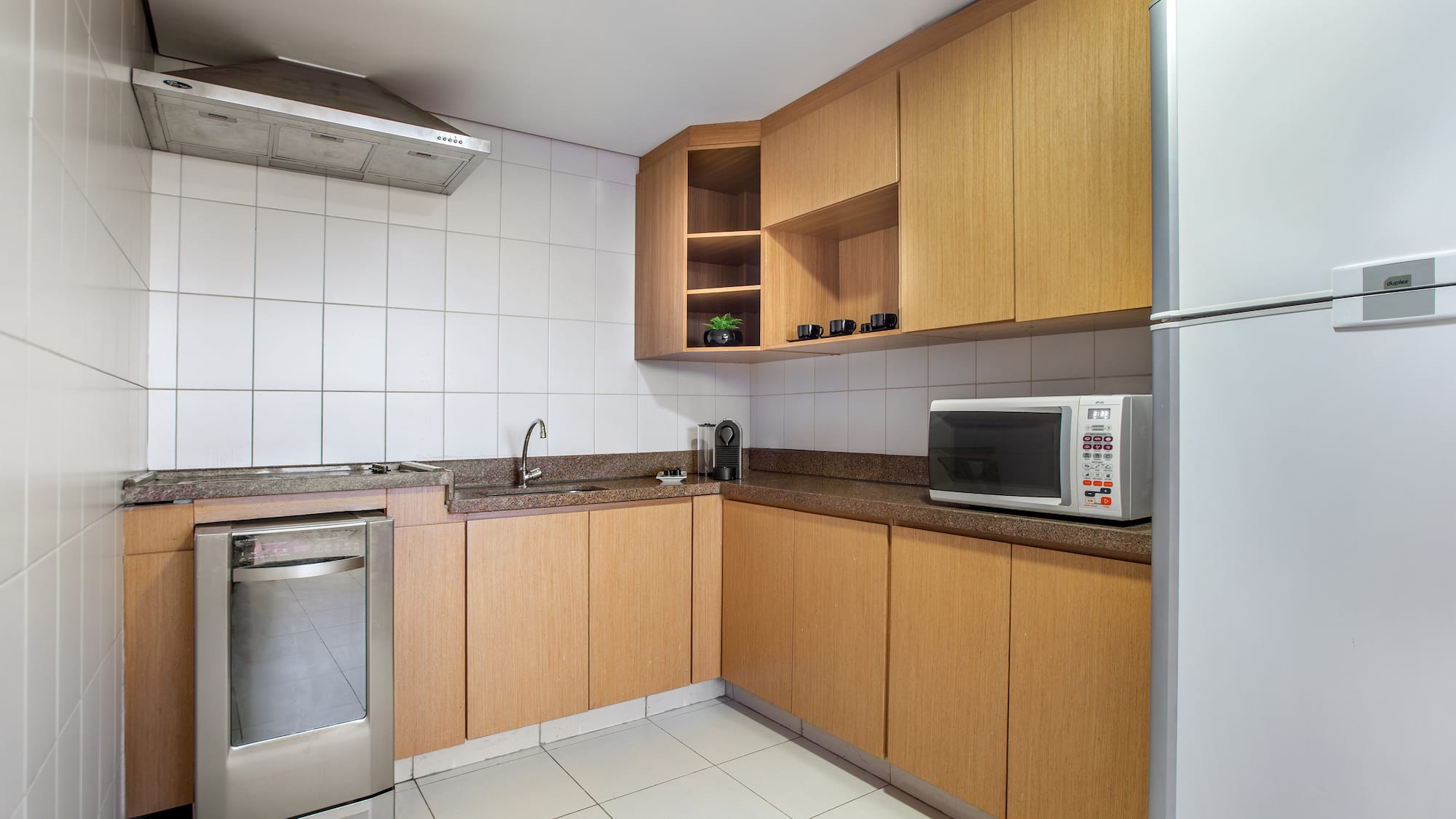 a kitchen with wooden cabinets and a microwave