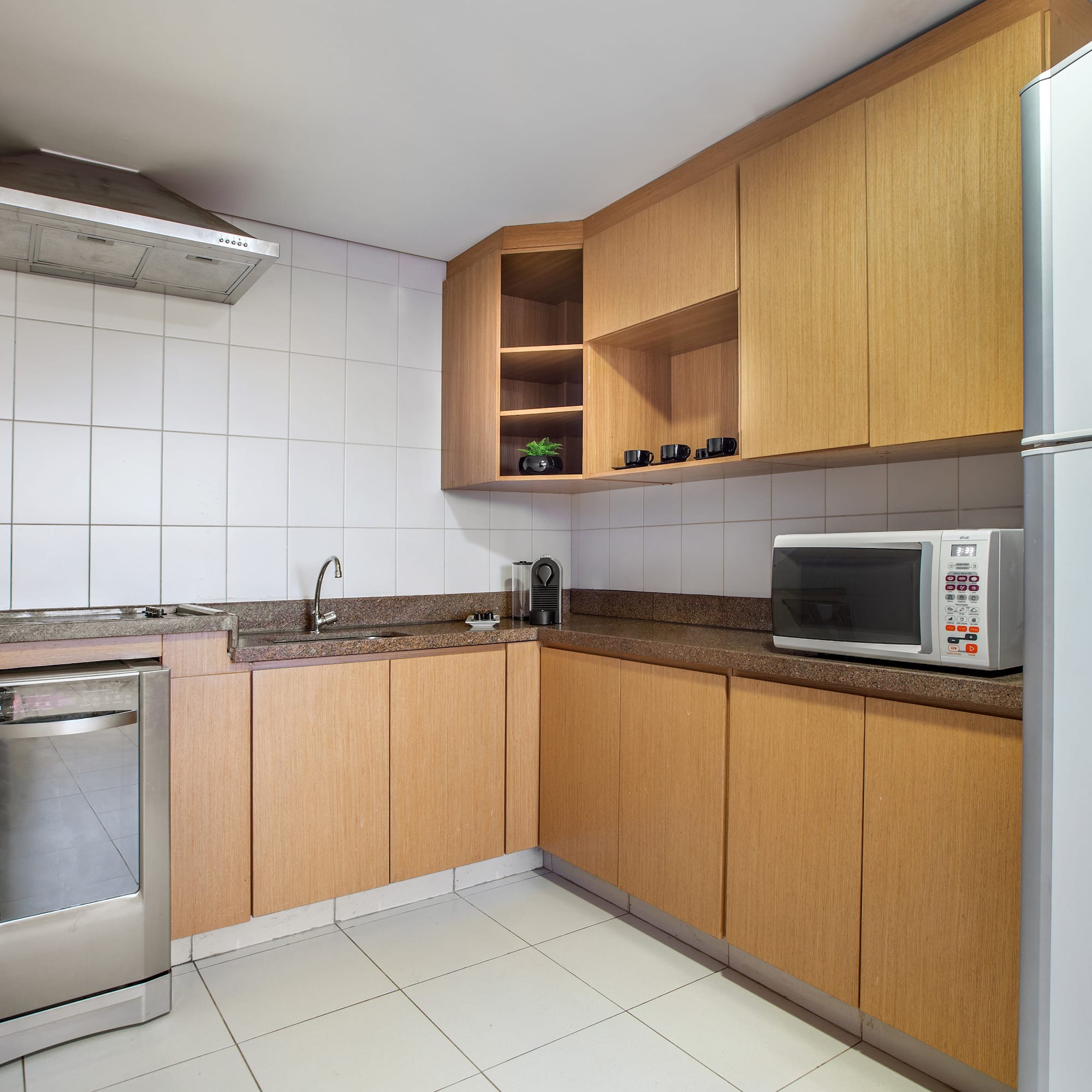 a kitchen with wooden cabinets and a microwave