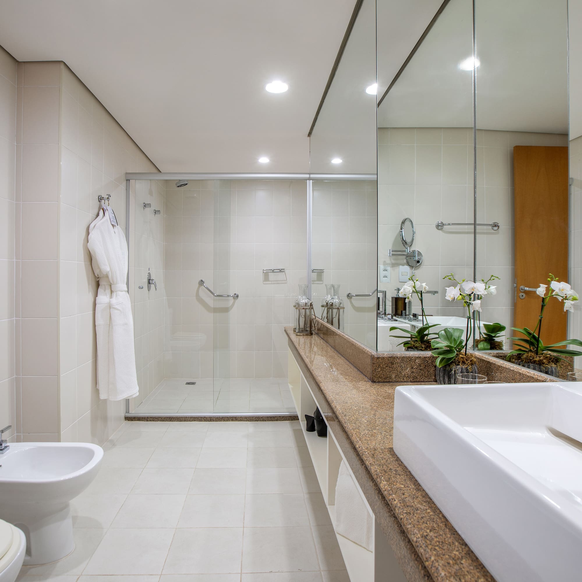 a bathroom with a large mirror and a sink