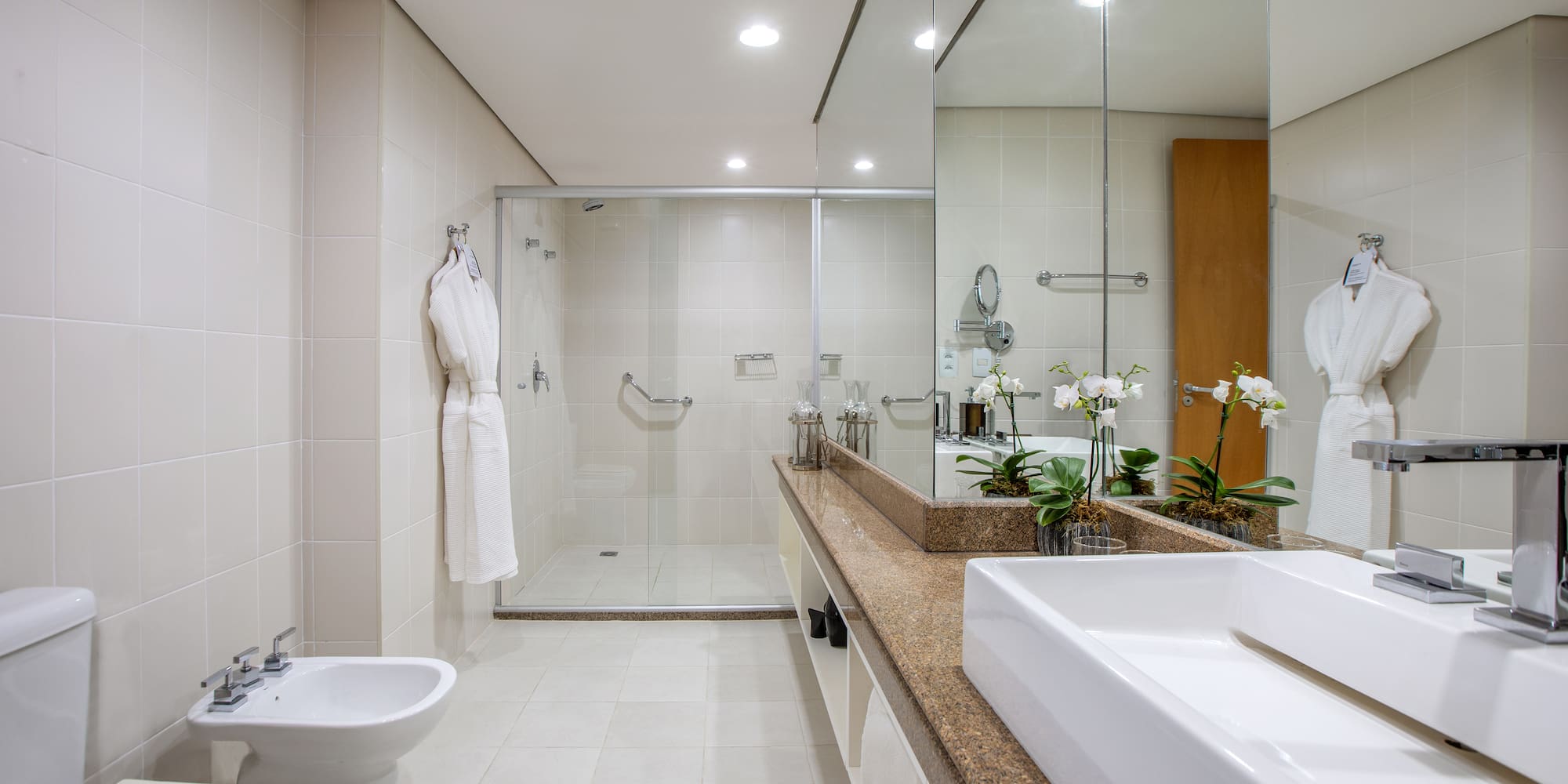 a bathroom with a large mirror and a sink