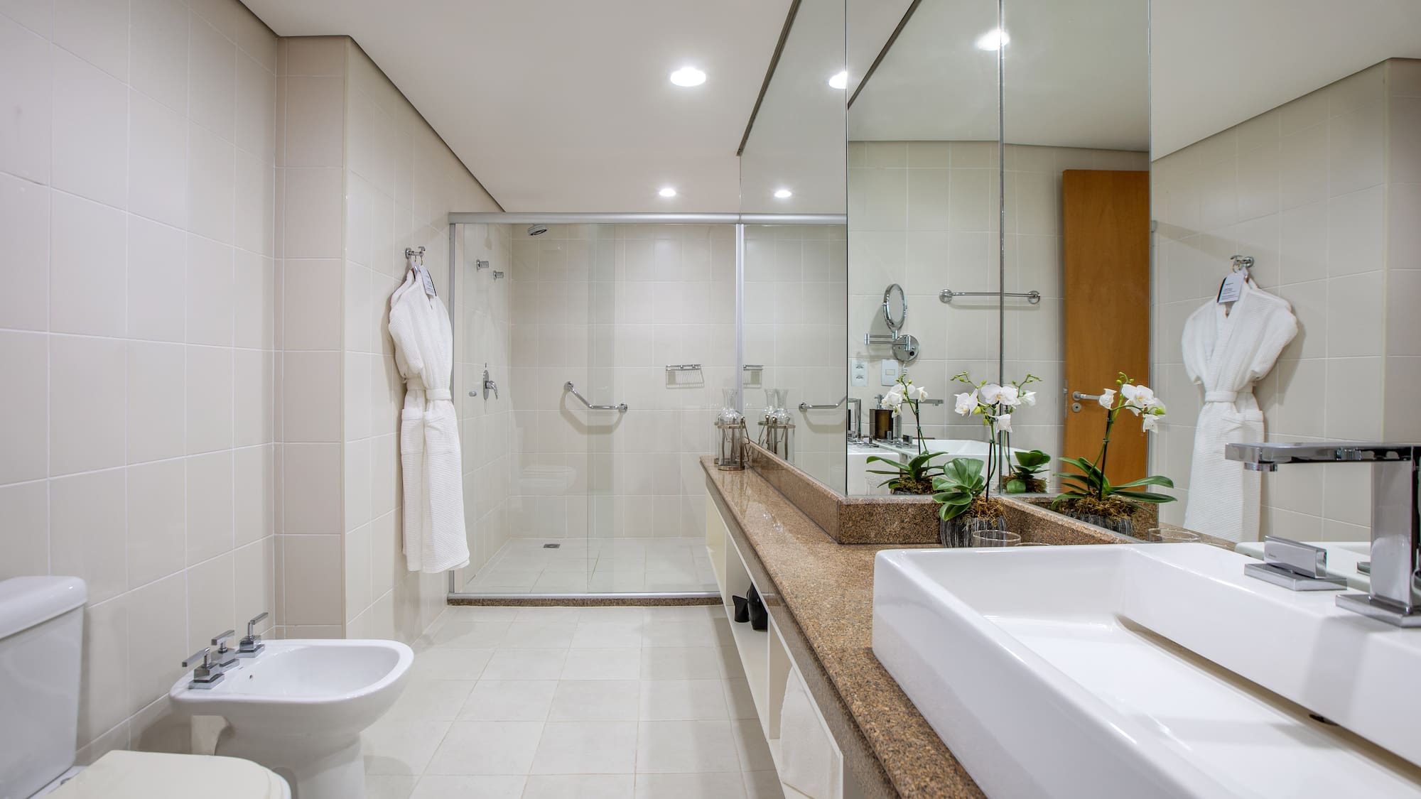 a bathroom with a large mirror and a sink