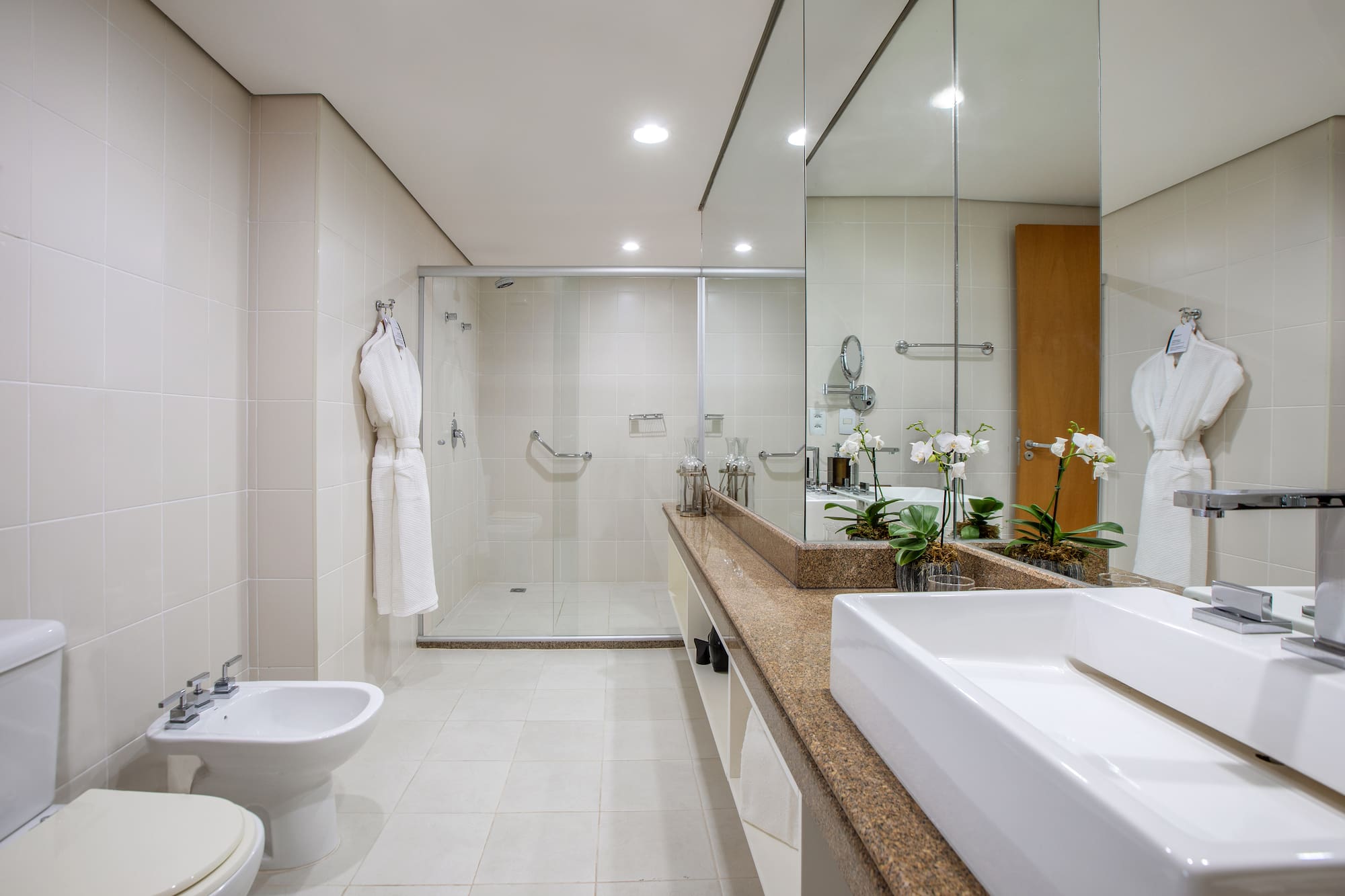 a bathroom with a large mirror and a sink