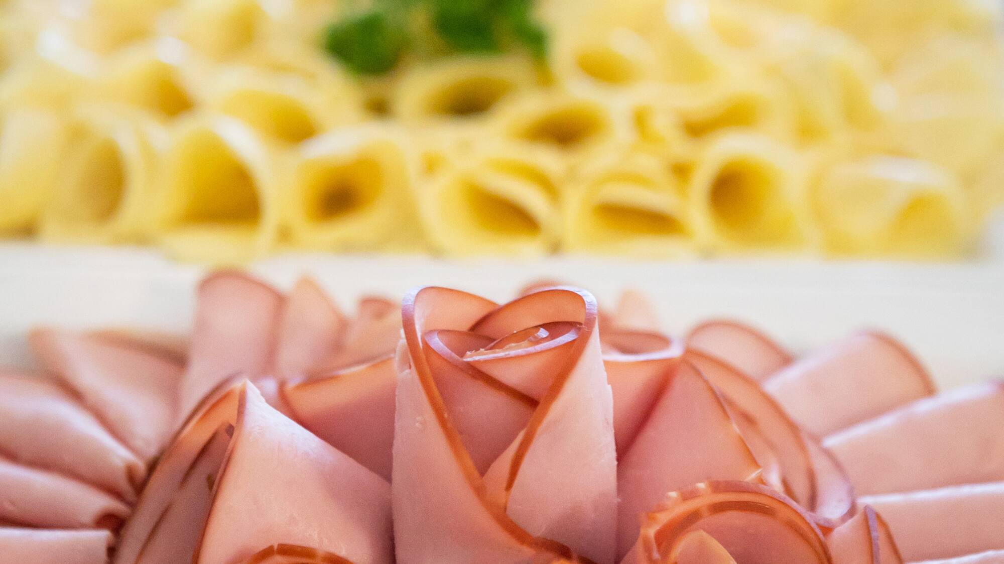 a plate of food with a flower shaped arrangement of meat