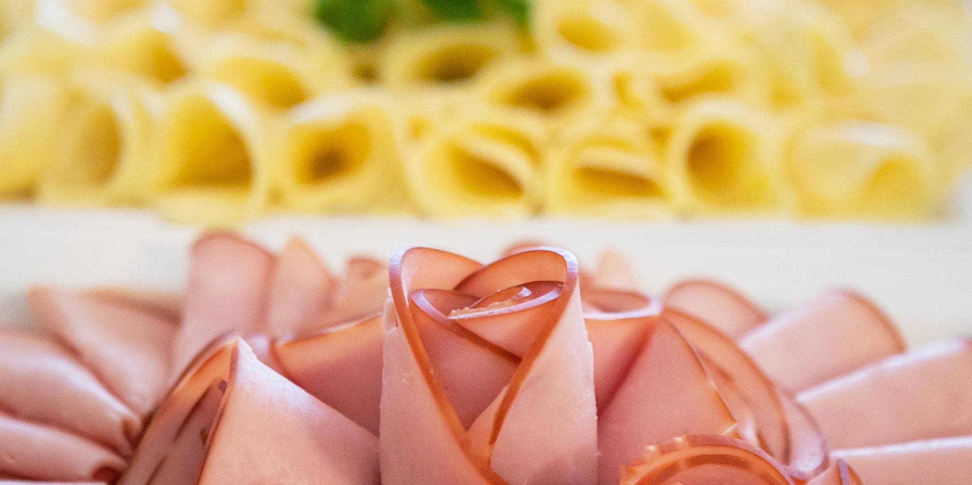 a plate of food with a flower shaped arrangement of meat