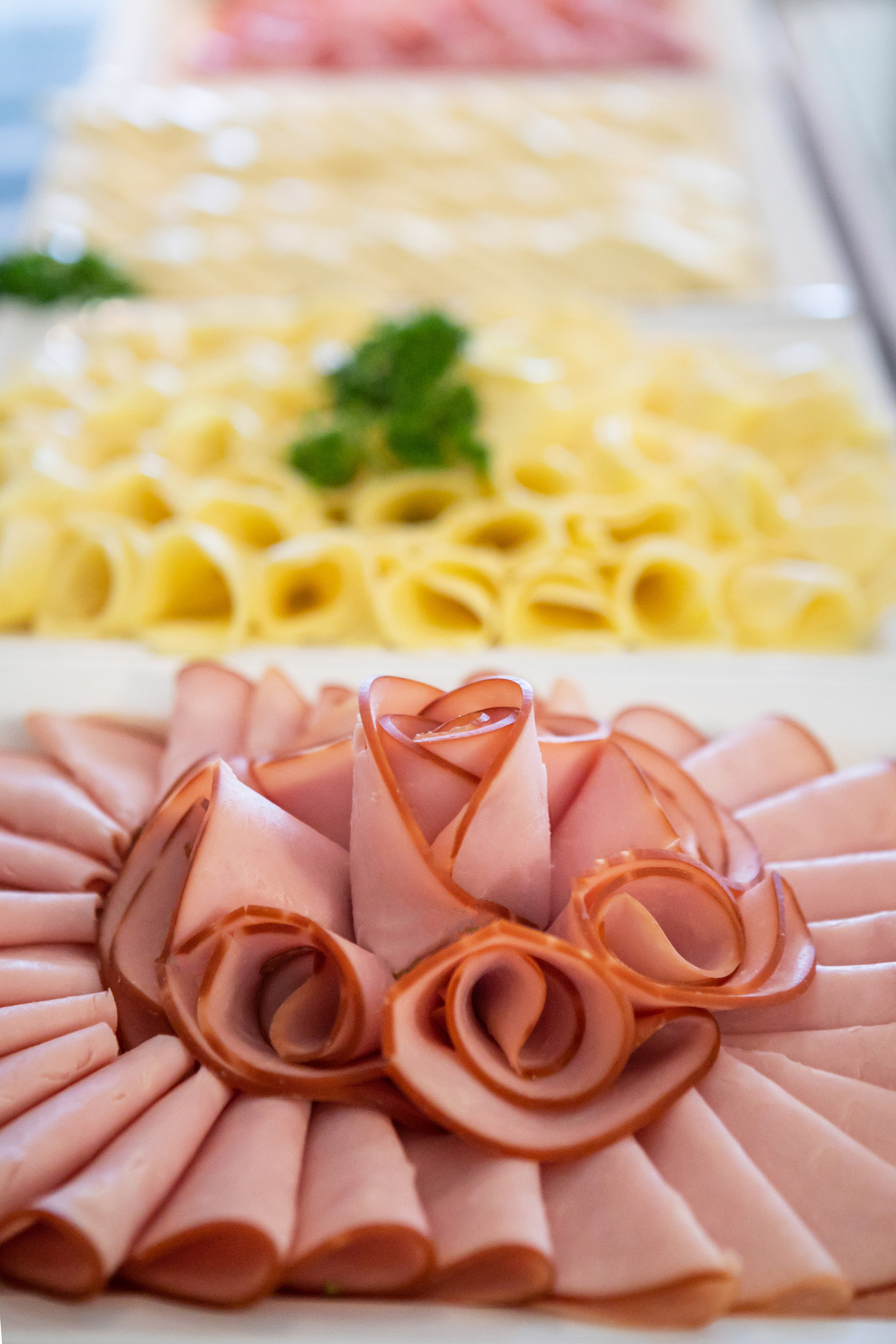 a plate of food with a flower shaped arrangement of meat