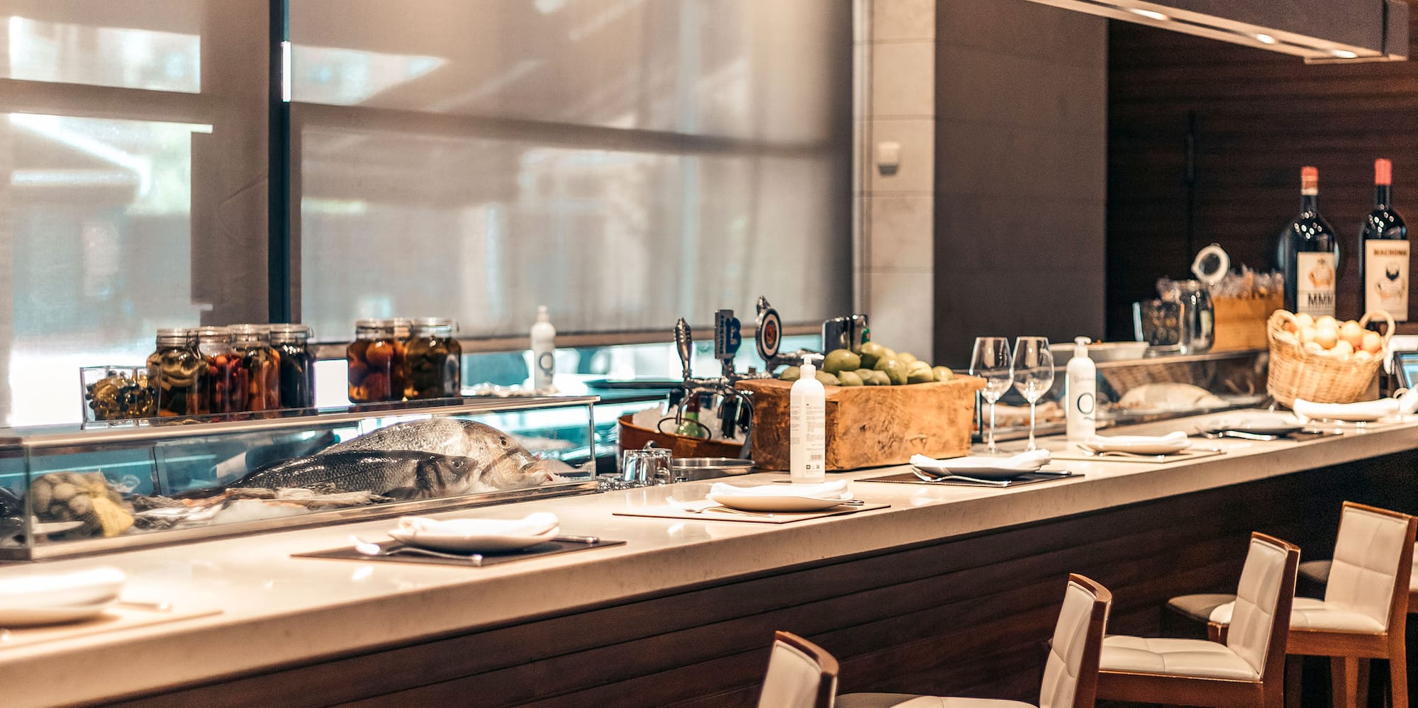 a bar with a counter and chairs
