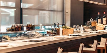 a bar with a counter and chairs