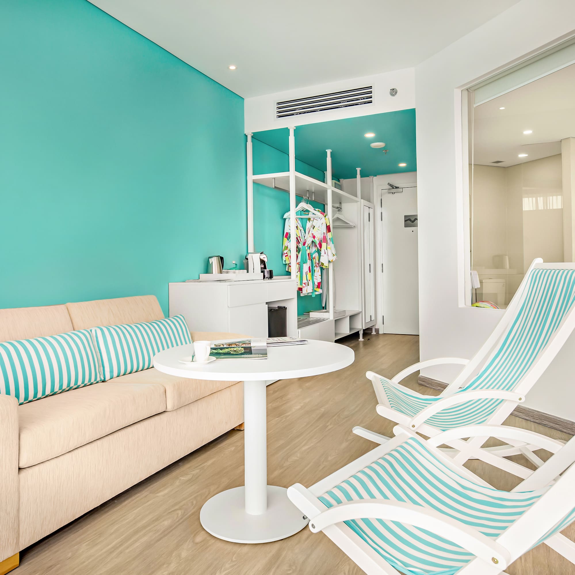 a room with a couch and chairs