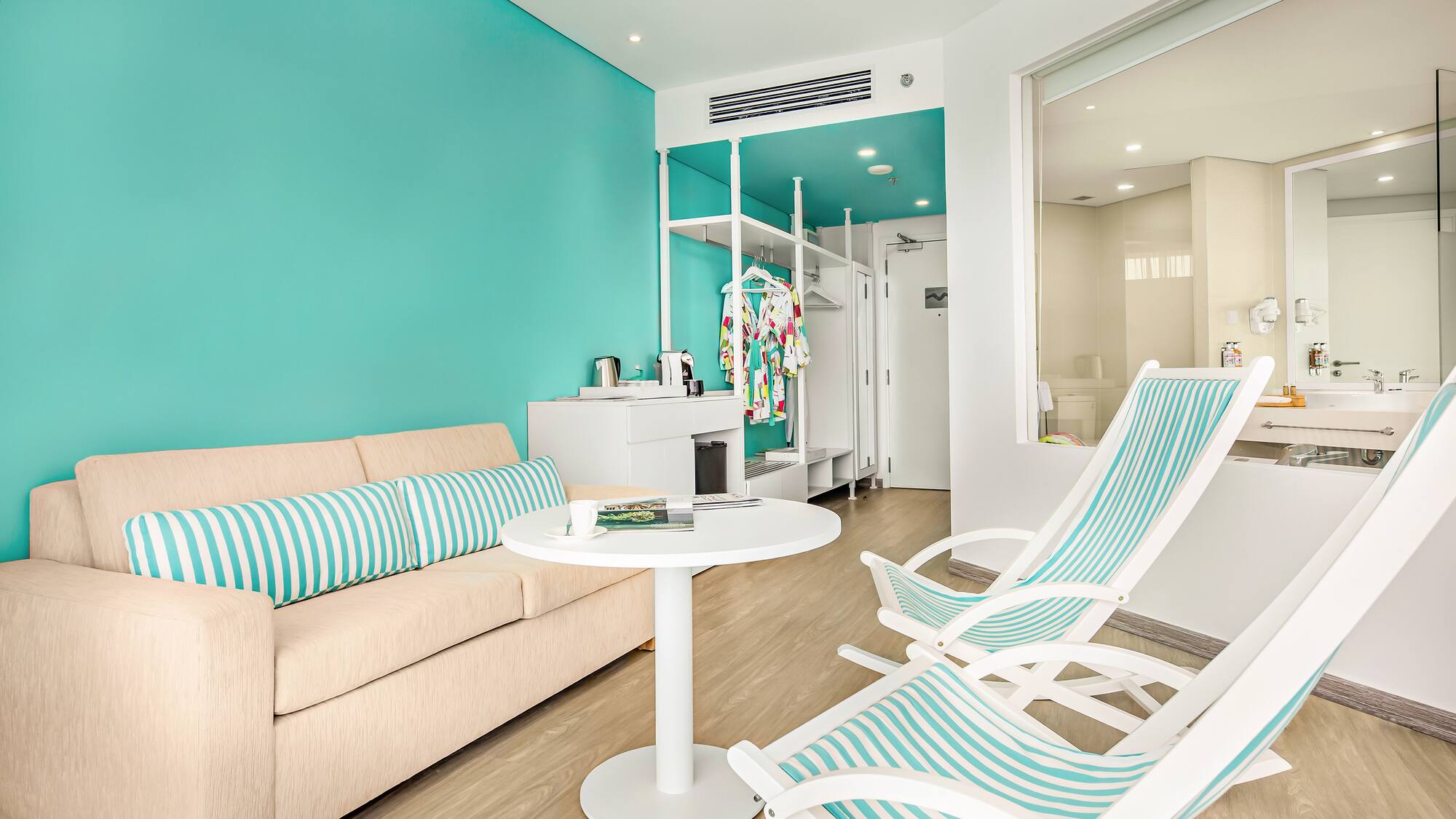 a room with a couch and chairs