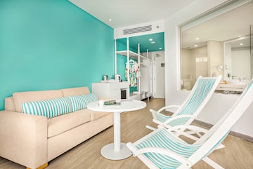 a room with a couch and chairs