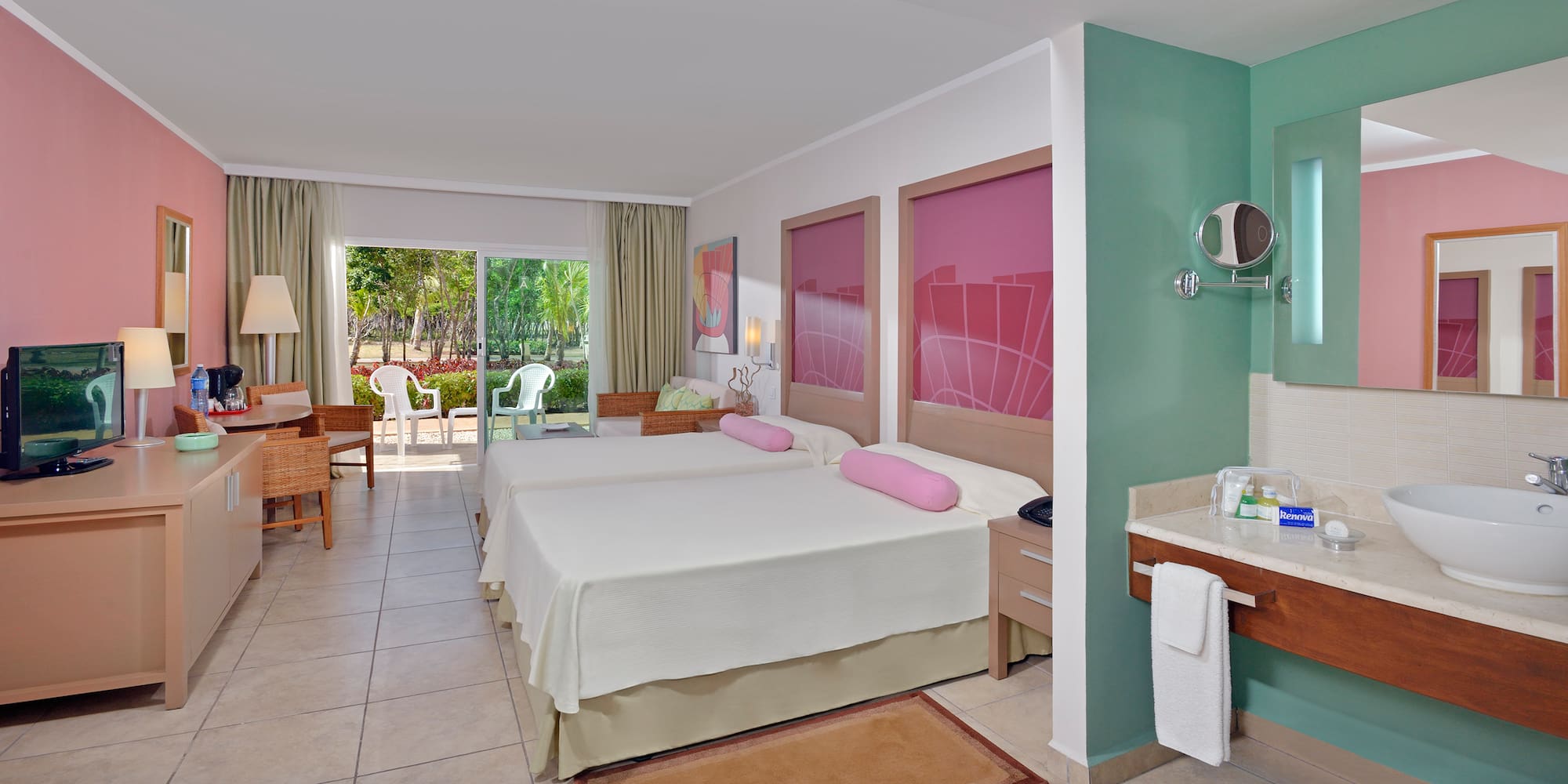 a room with two beds and a sink