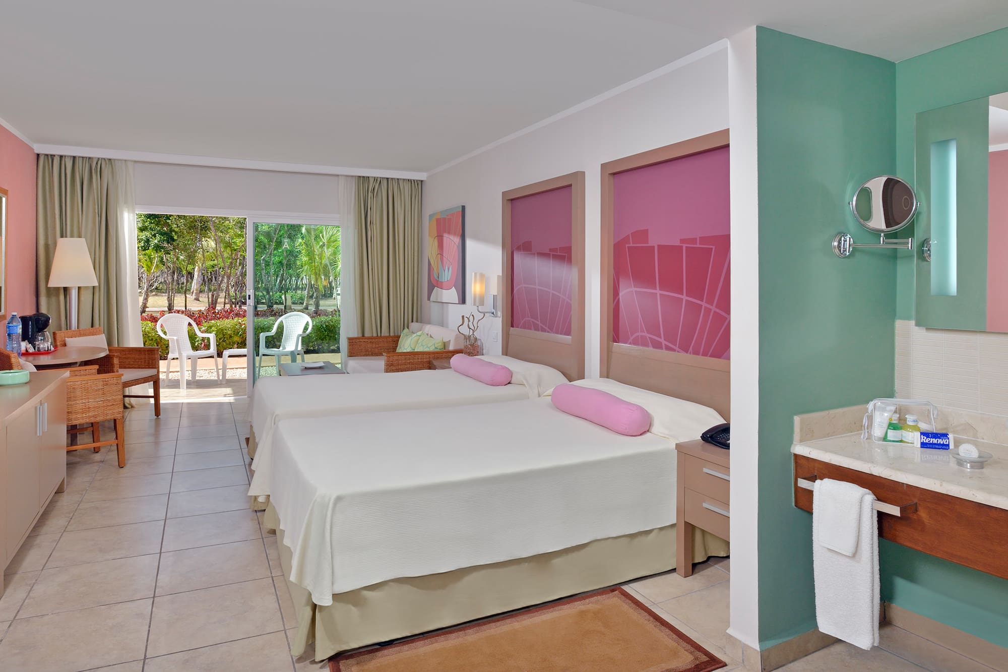 a room with two beds and a sink