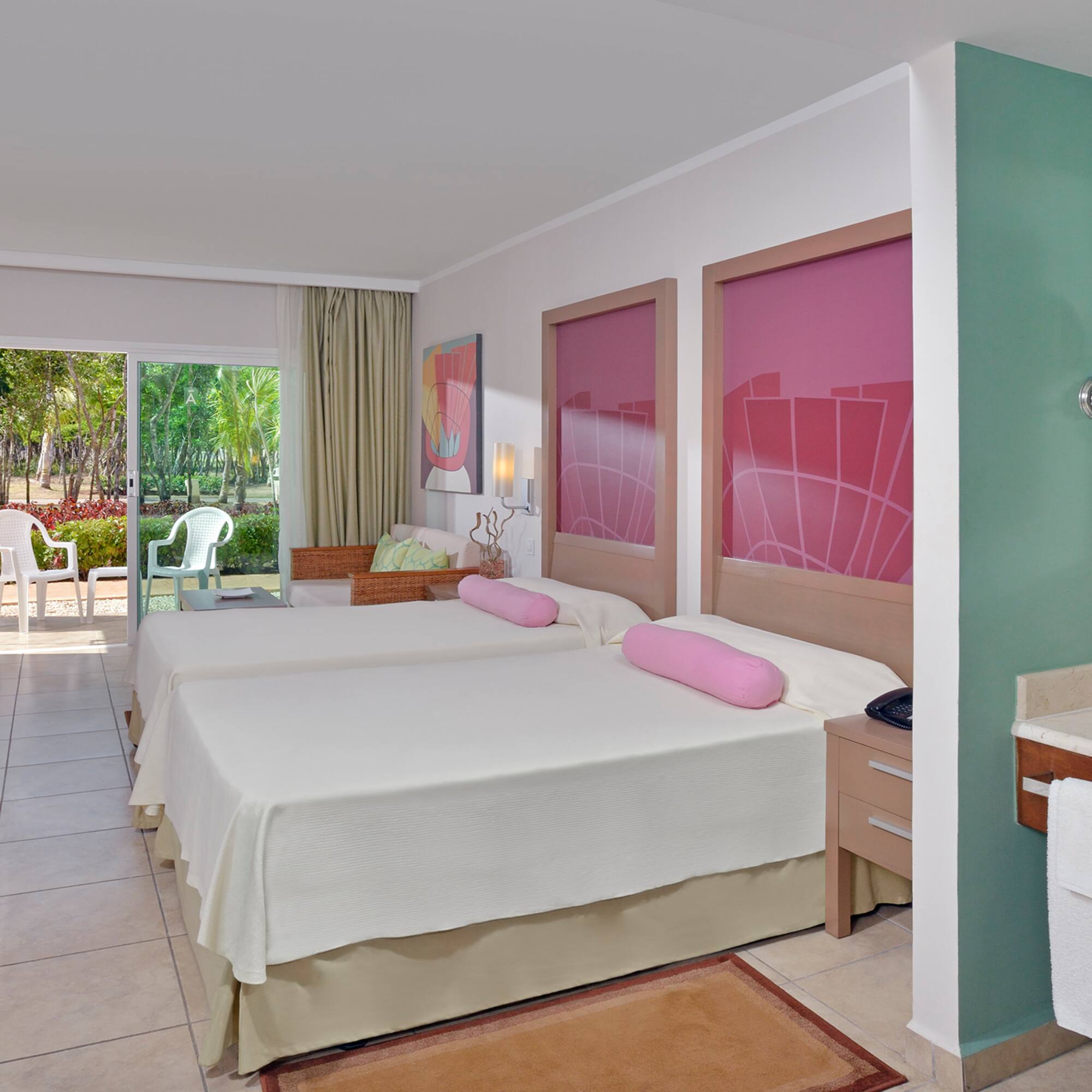 a room with two beds and a sink