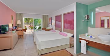 a room with two beds and a sink