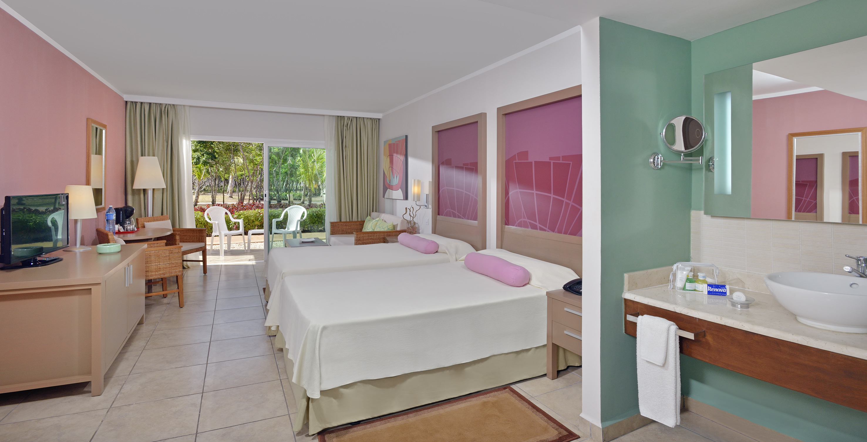 a room with two beds and a sink