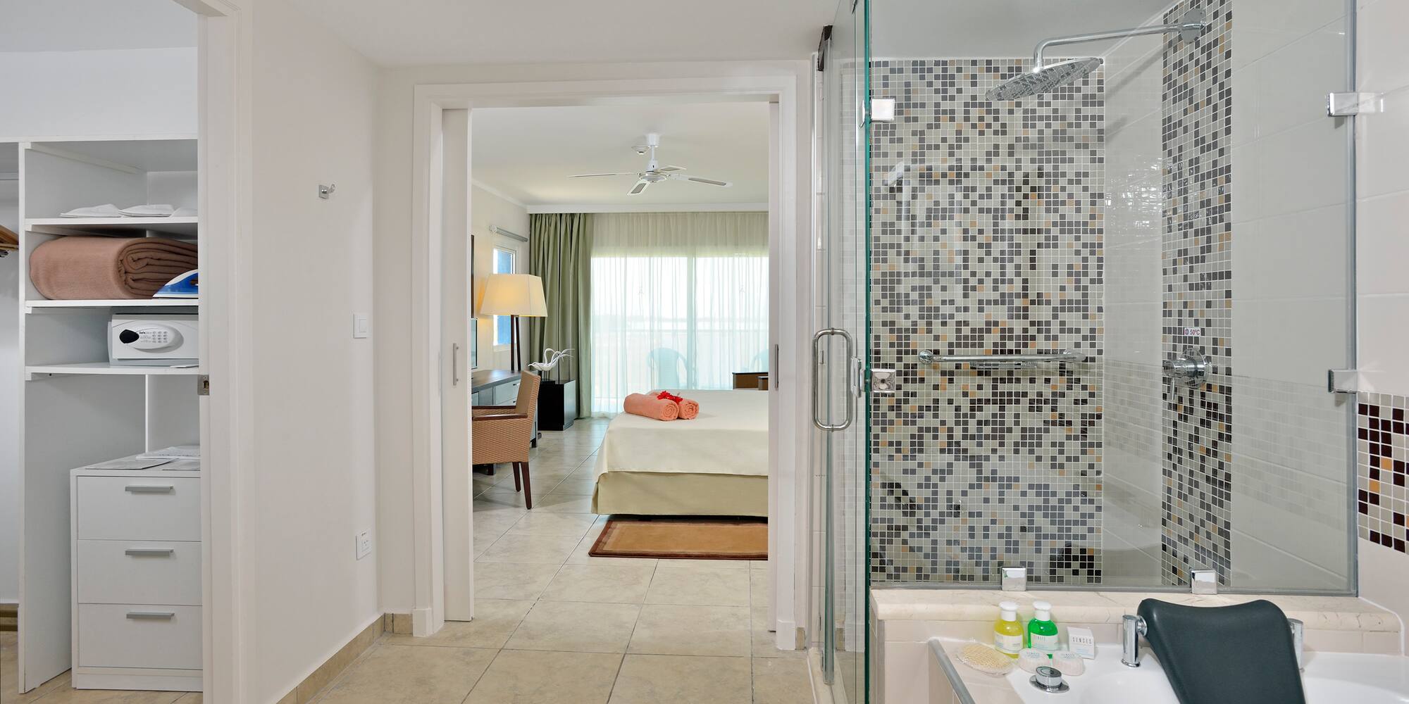 a bathroom with a shower and a bed