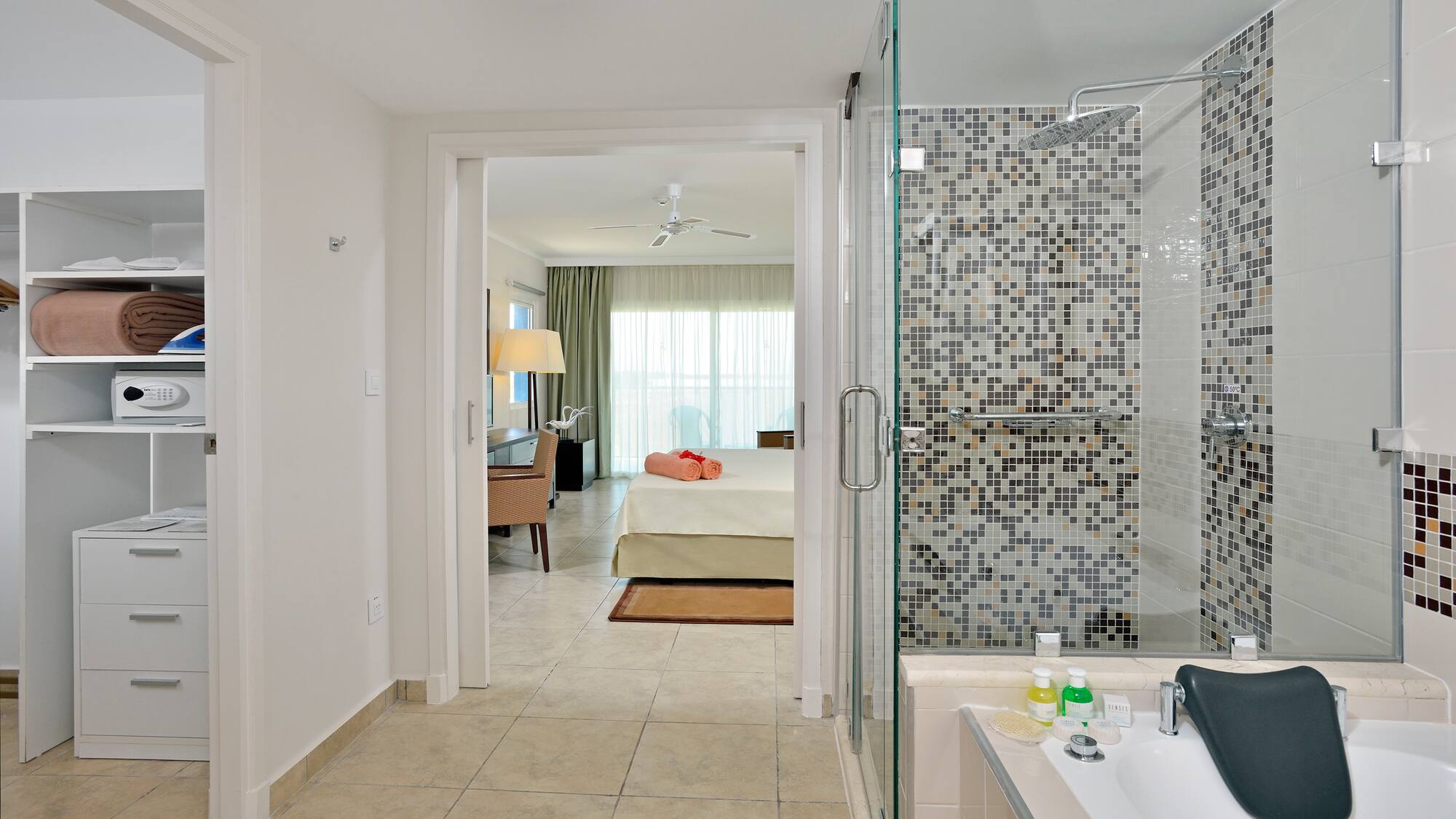 a bathroom with a shower and a bed