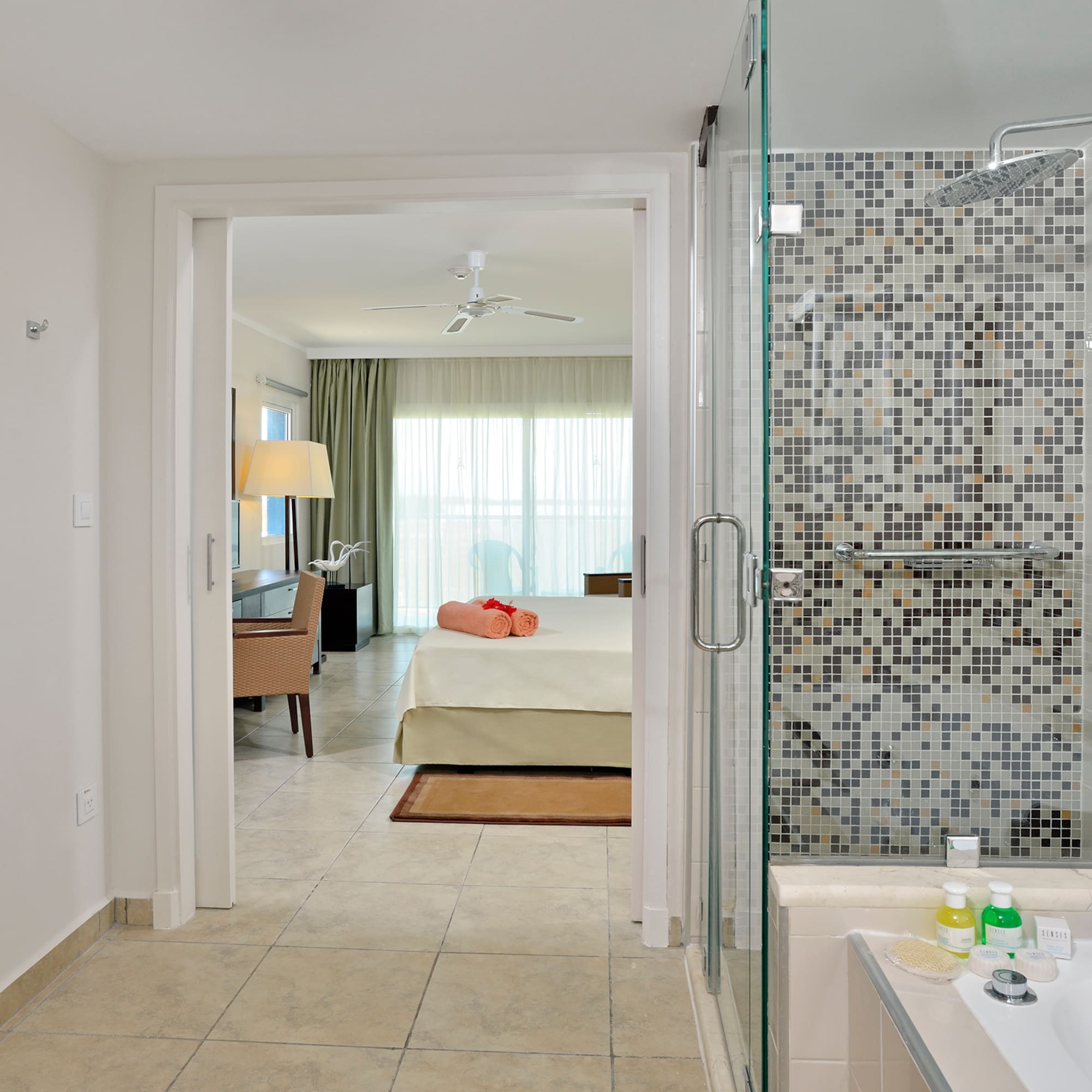 a bathroom with a shower and a bed