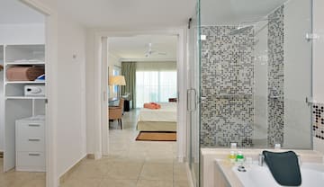 a bathroom with a shower and a bed