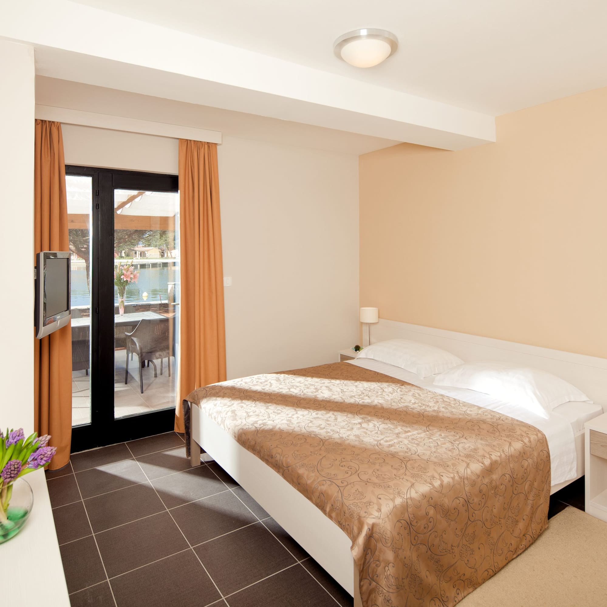 a bedroom with a bed and a glass door