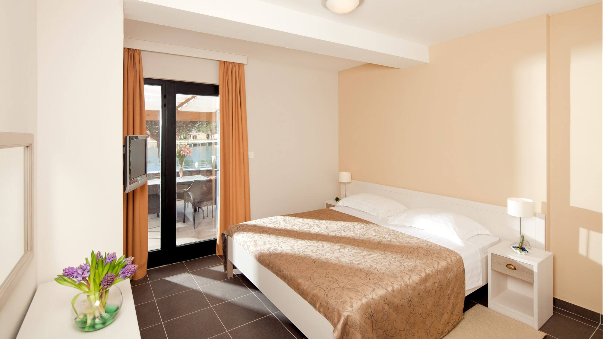 a bedroom with a bed and a glass door