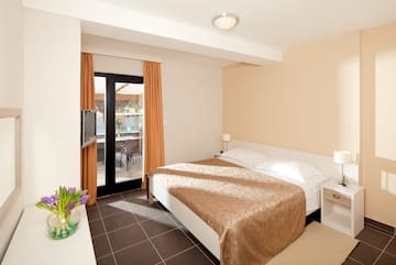 a bedroom with a bed and a glass door