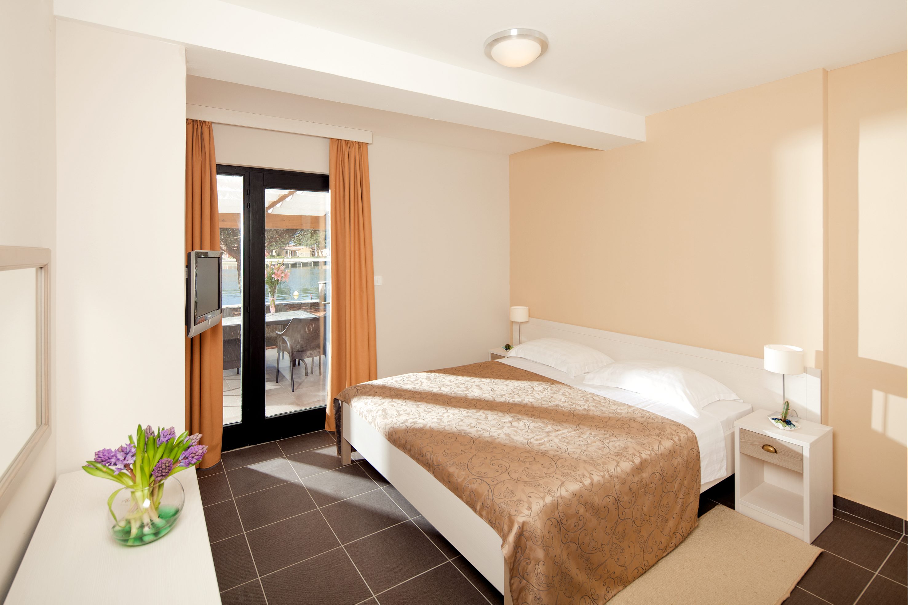 a bedroom with a bed and a glass door