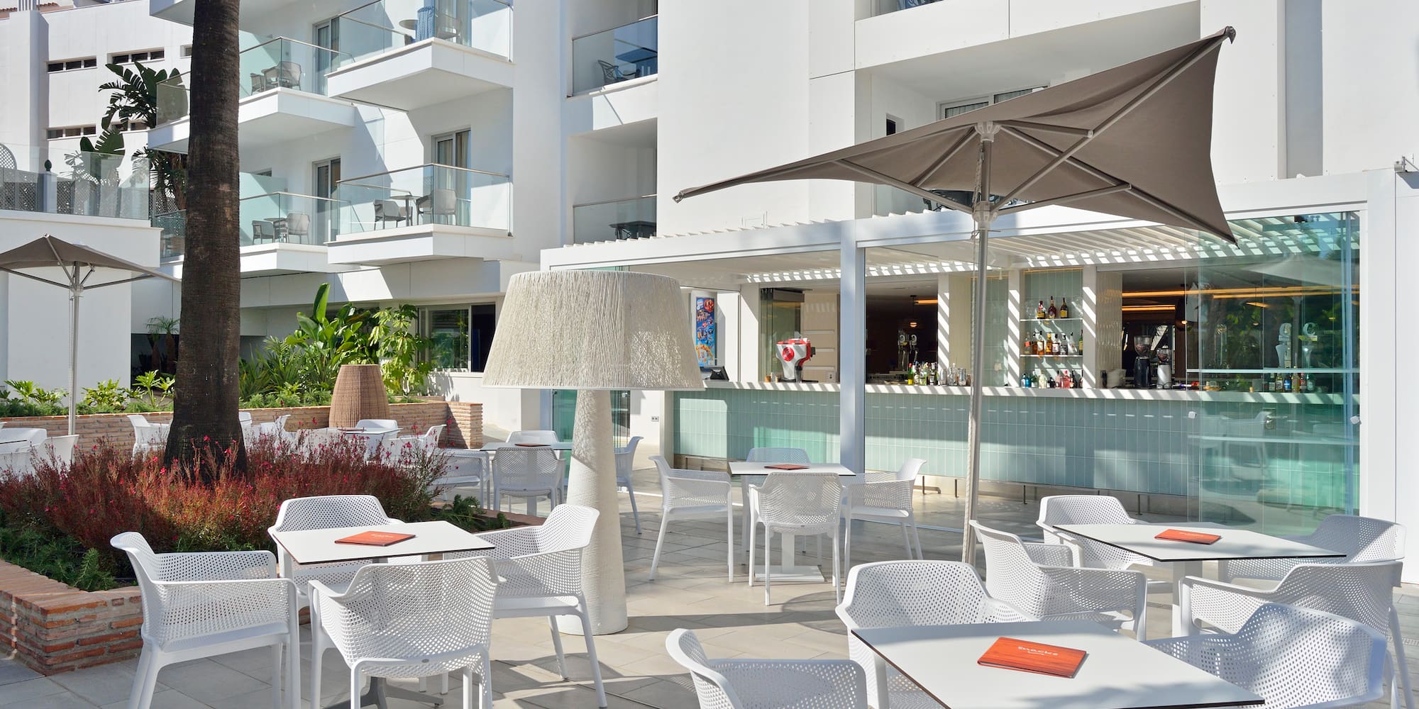 a patio with tables and chairs and umbrellas