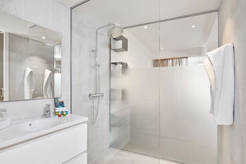 a bathroom with a shower and sink