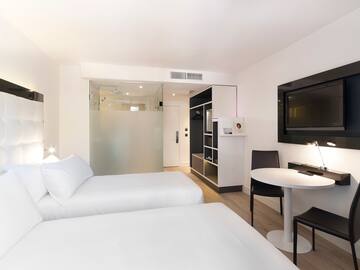 a room with two beds and a tv