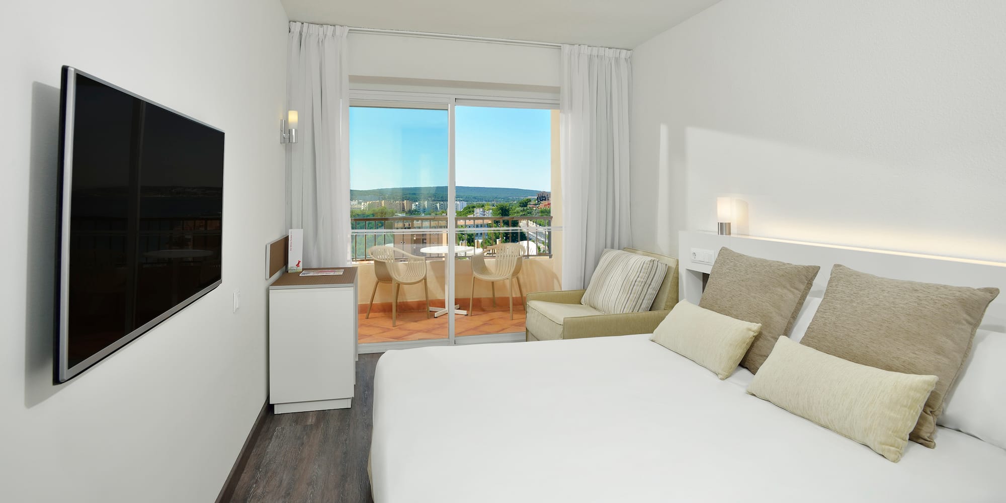 a bedroom with a bed and a television