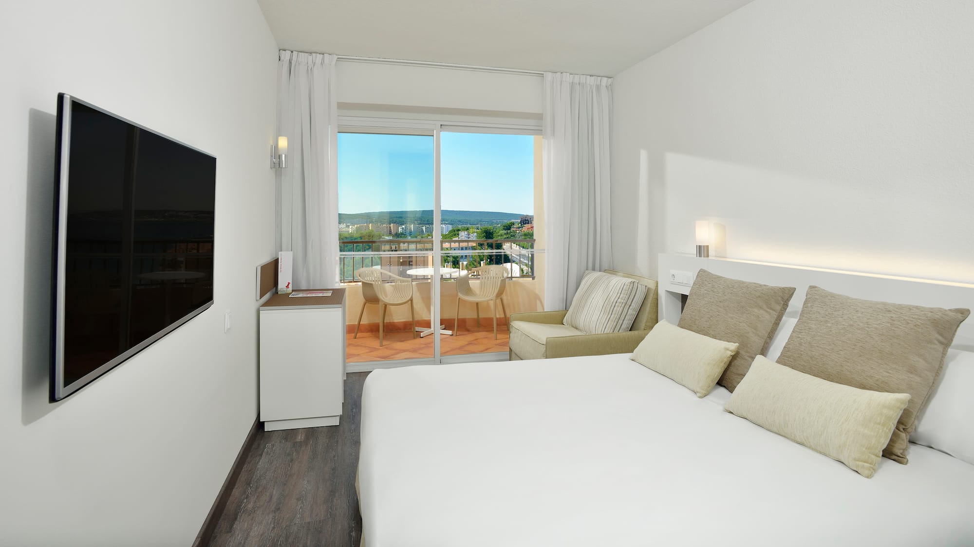 a bedroom with a bed and a television