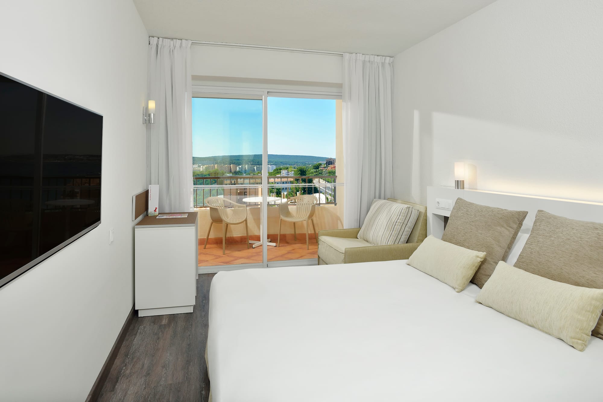 a bedroom with a bed and a television