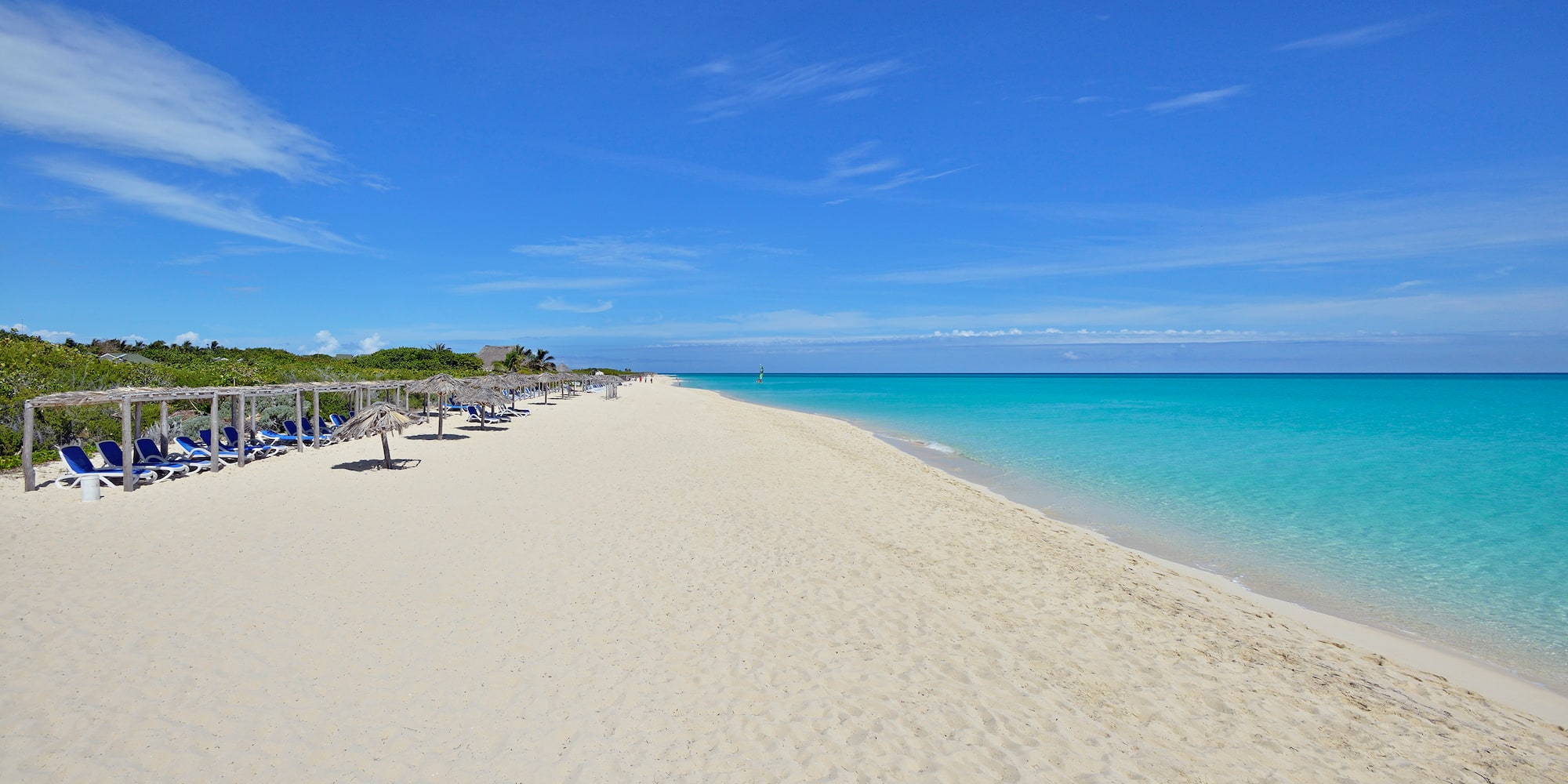 a beach with umbrellas and chairs