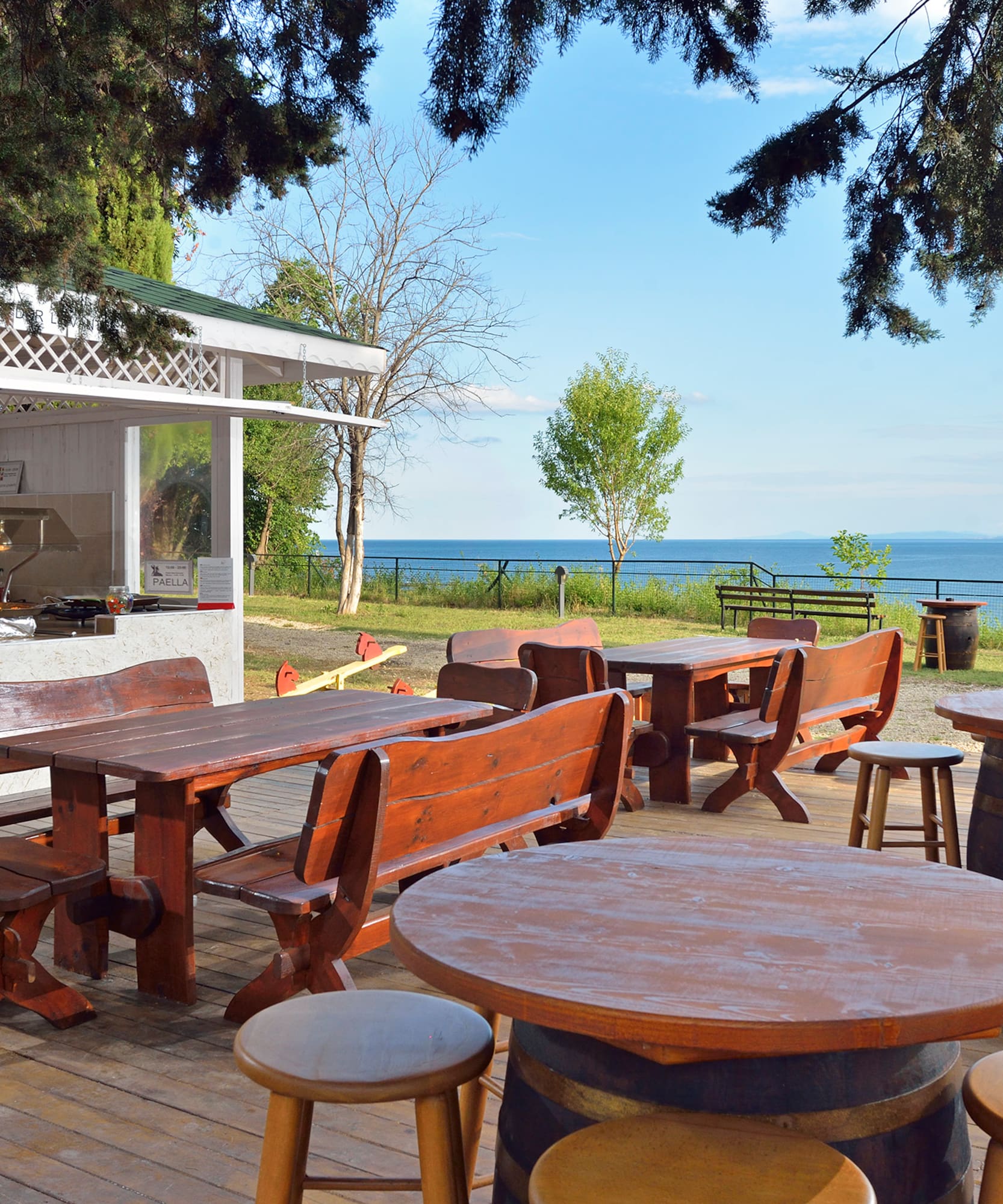a table and chairs outside with a view of the ocean