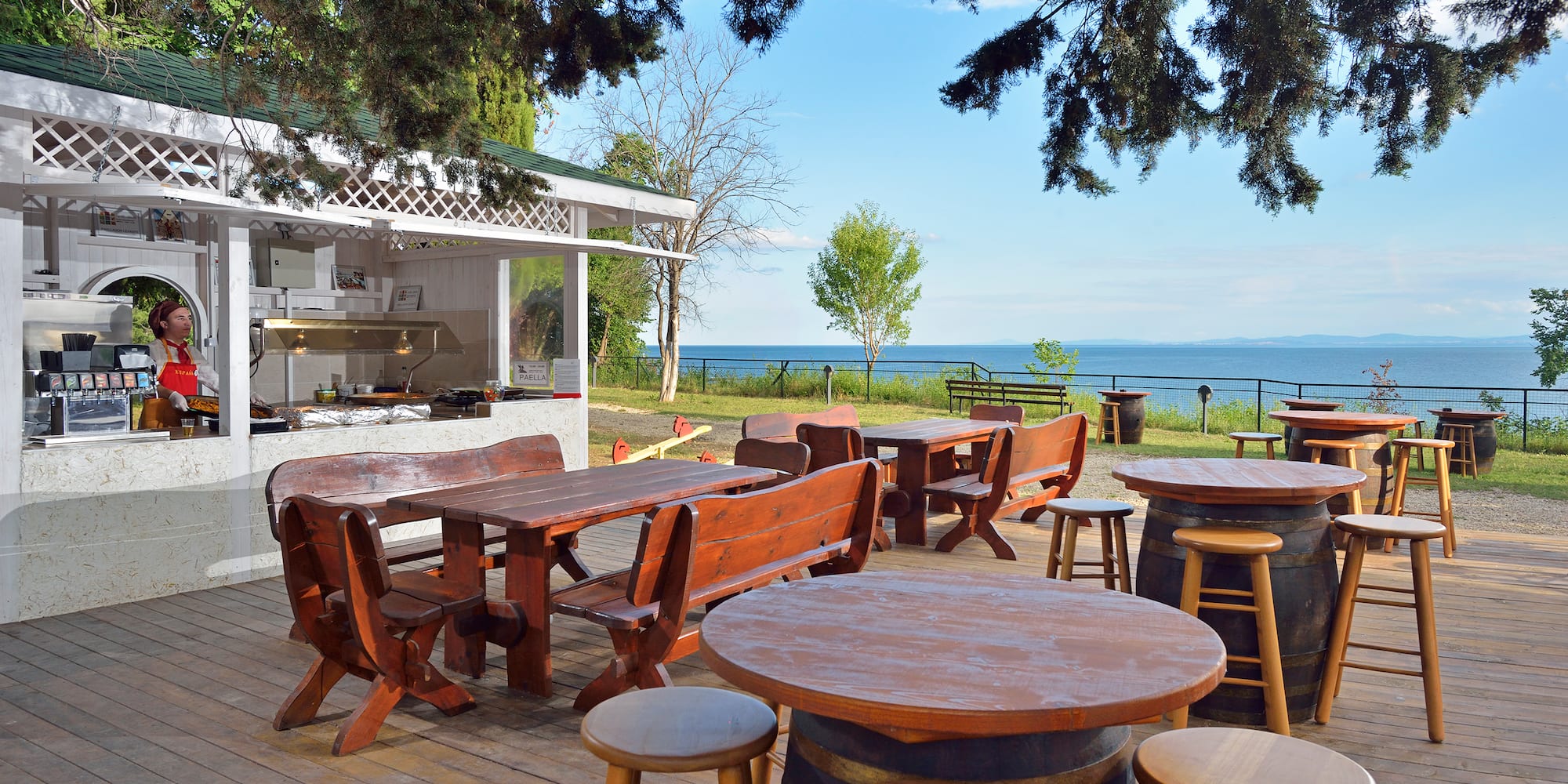 a table and chairs outside with a view of the ocean