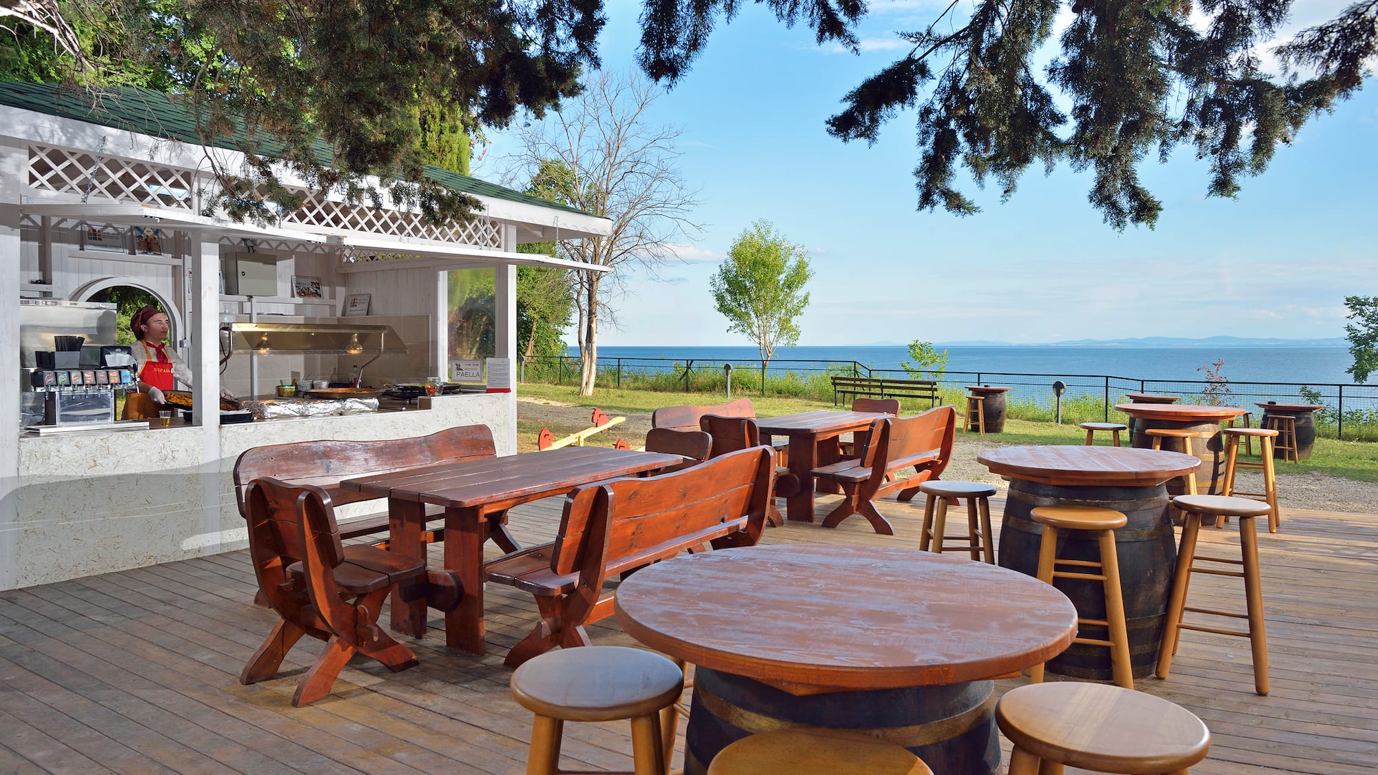 a table and chairs outside with a view of the ocean