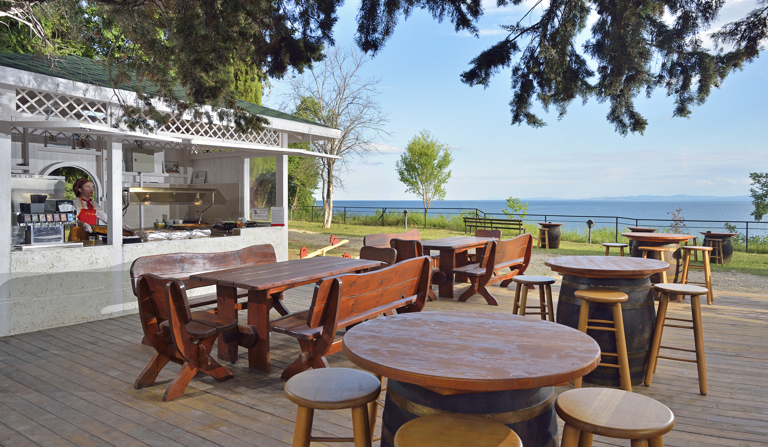 a table and chairs outside with a view of the ocean