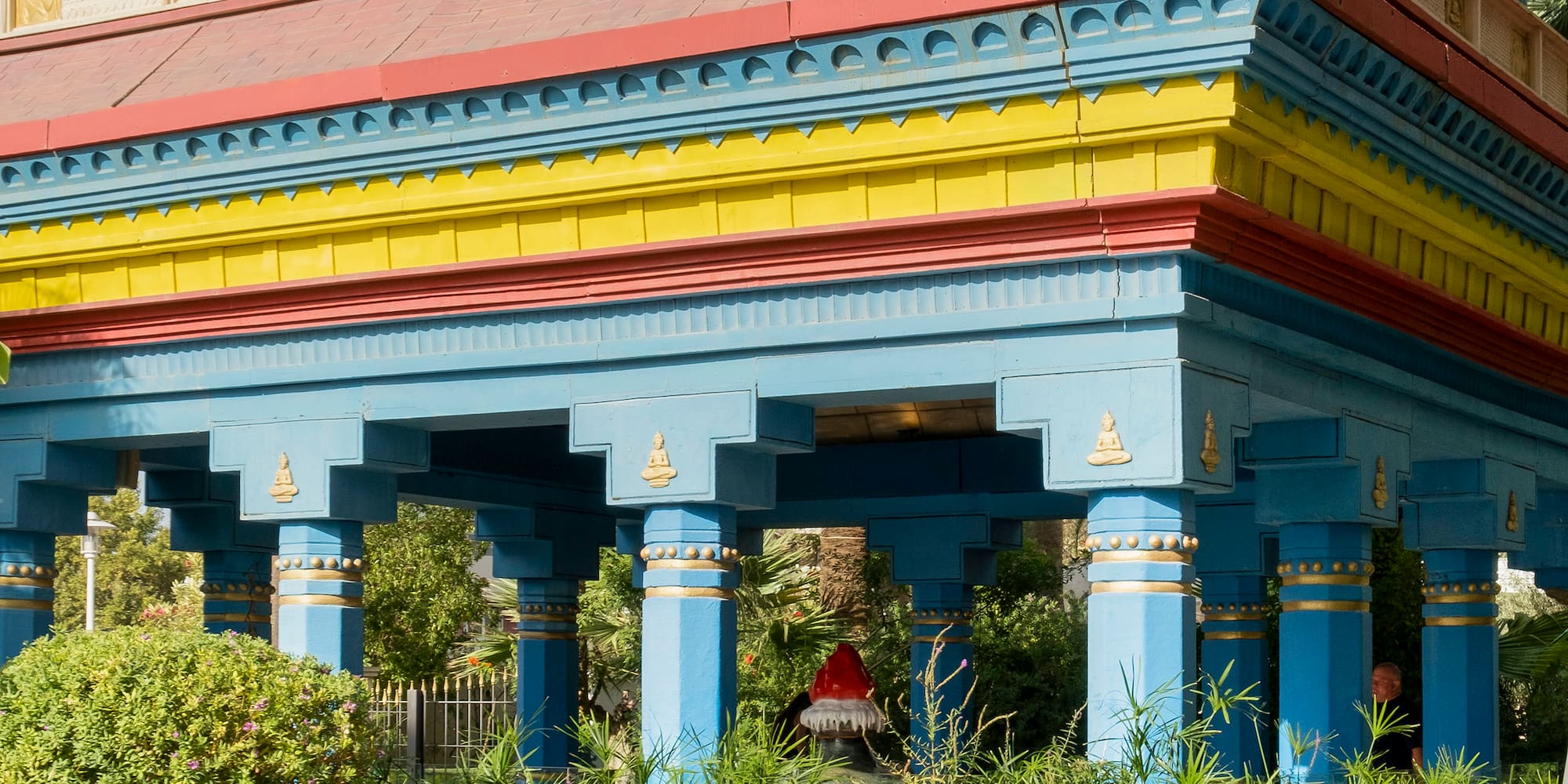 a building with a tall roof and columns