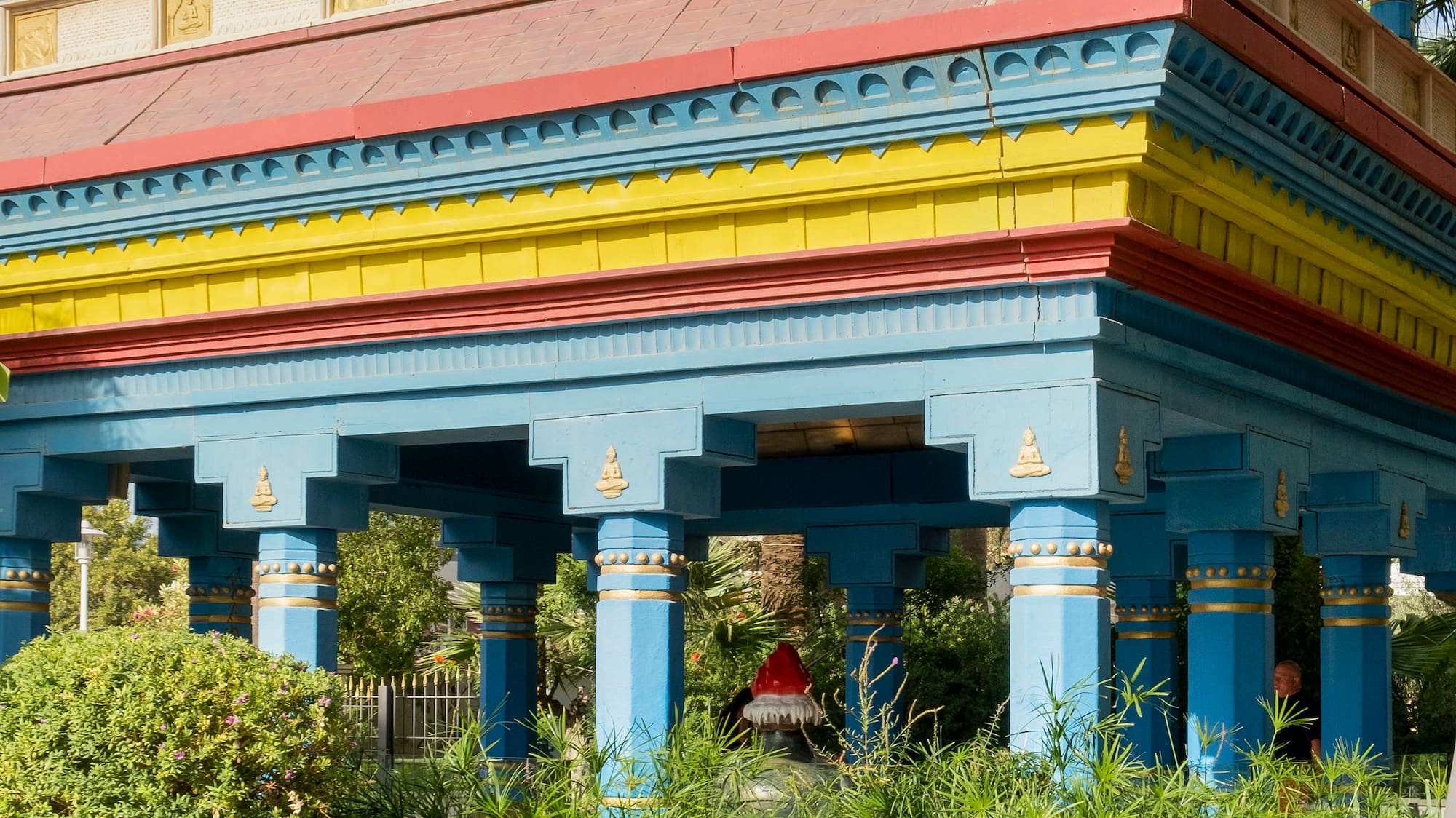 a building with a tall roof and columns