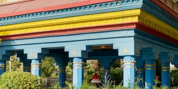a building with a tall roof and columns