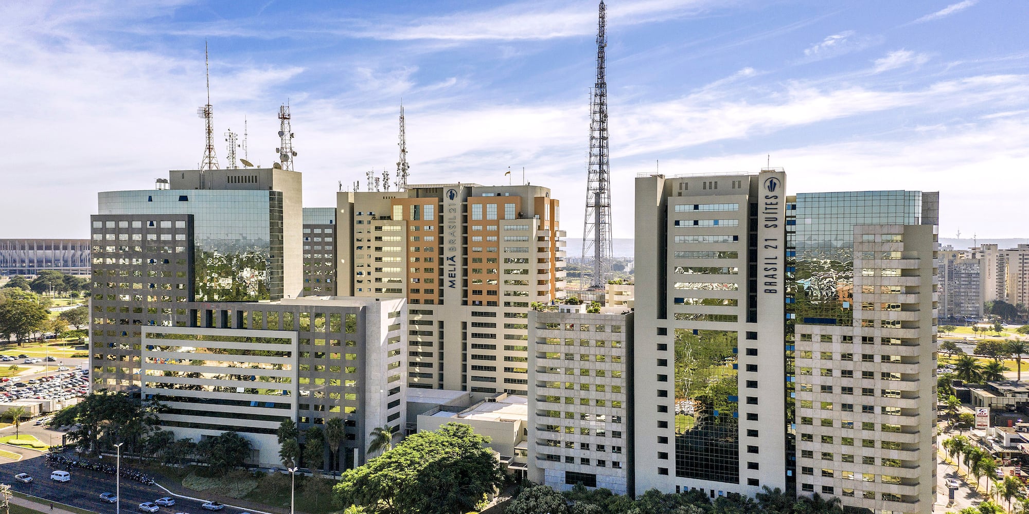 a group of buildings with cars parked in front of them
