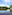 a body of water with trees and a gazebo